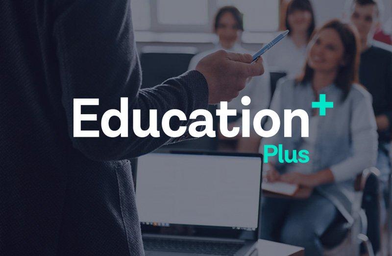 a man is standing in front of a group of people with a laptop