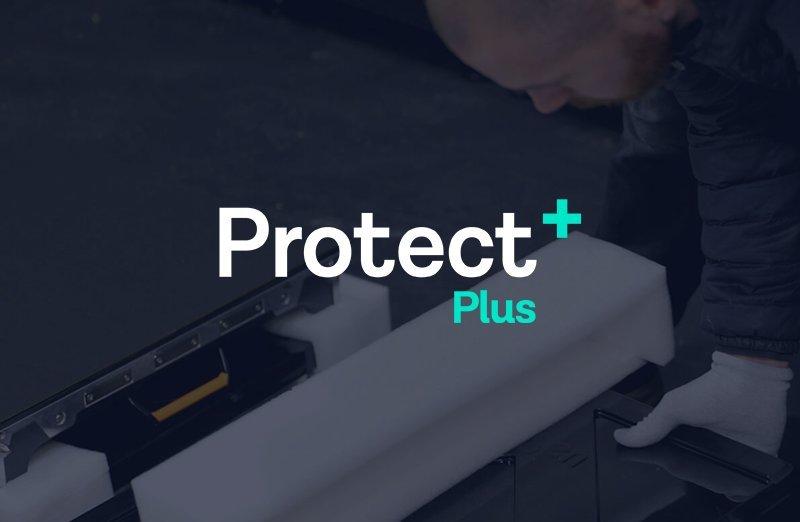 a man is working on a machine and the Protect Plus logo