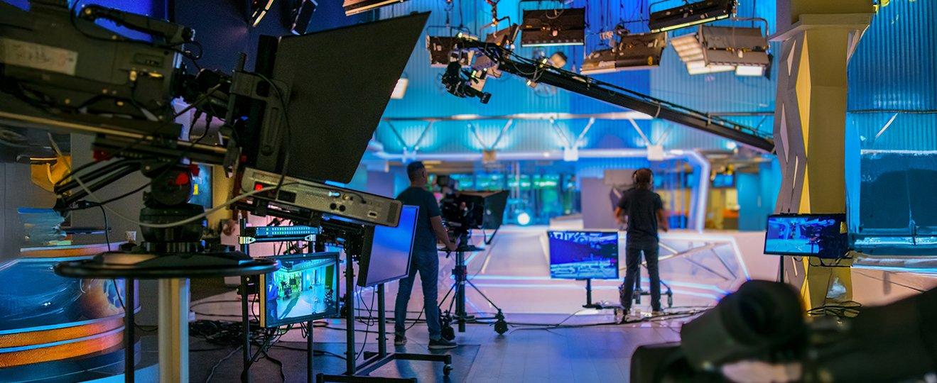 a room with a bunch of cameras and a bunch of people