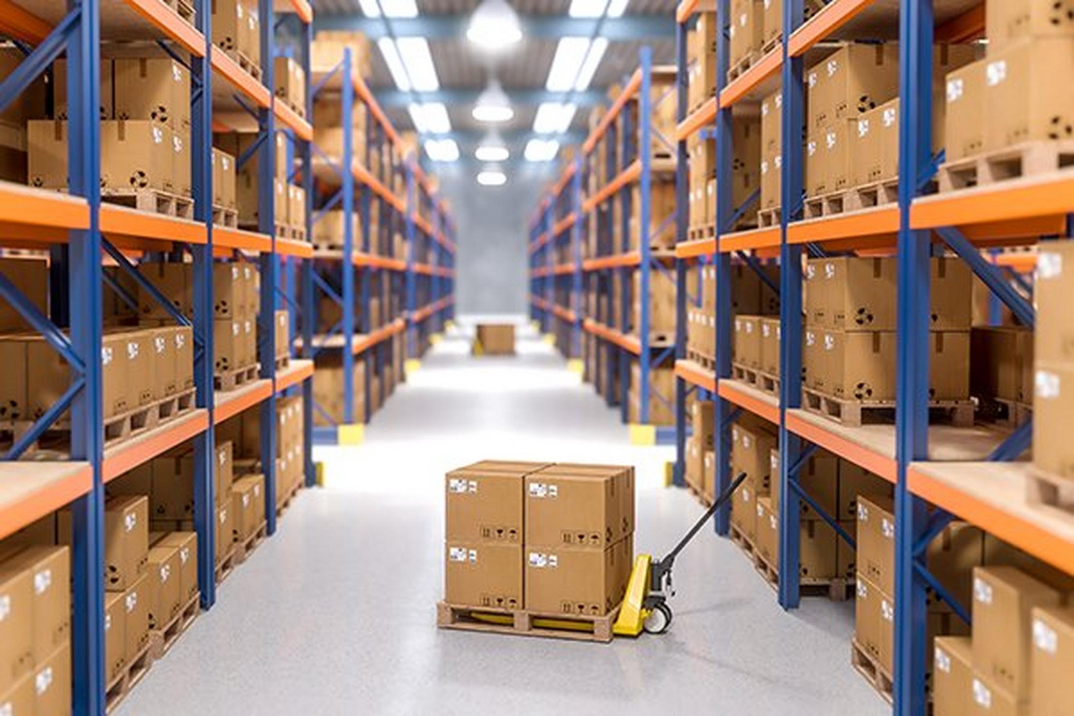 a warehouse with a cart and boxes in the middle of the aisle