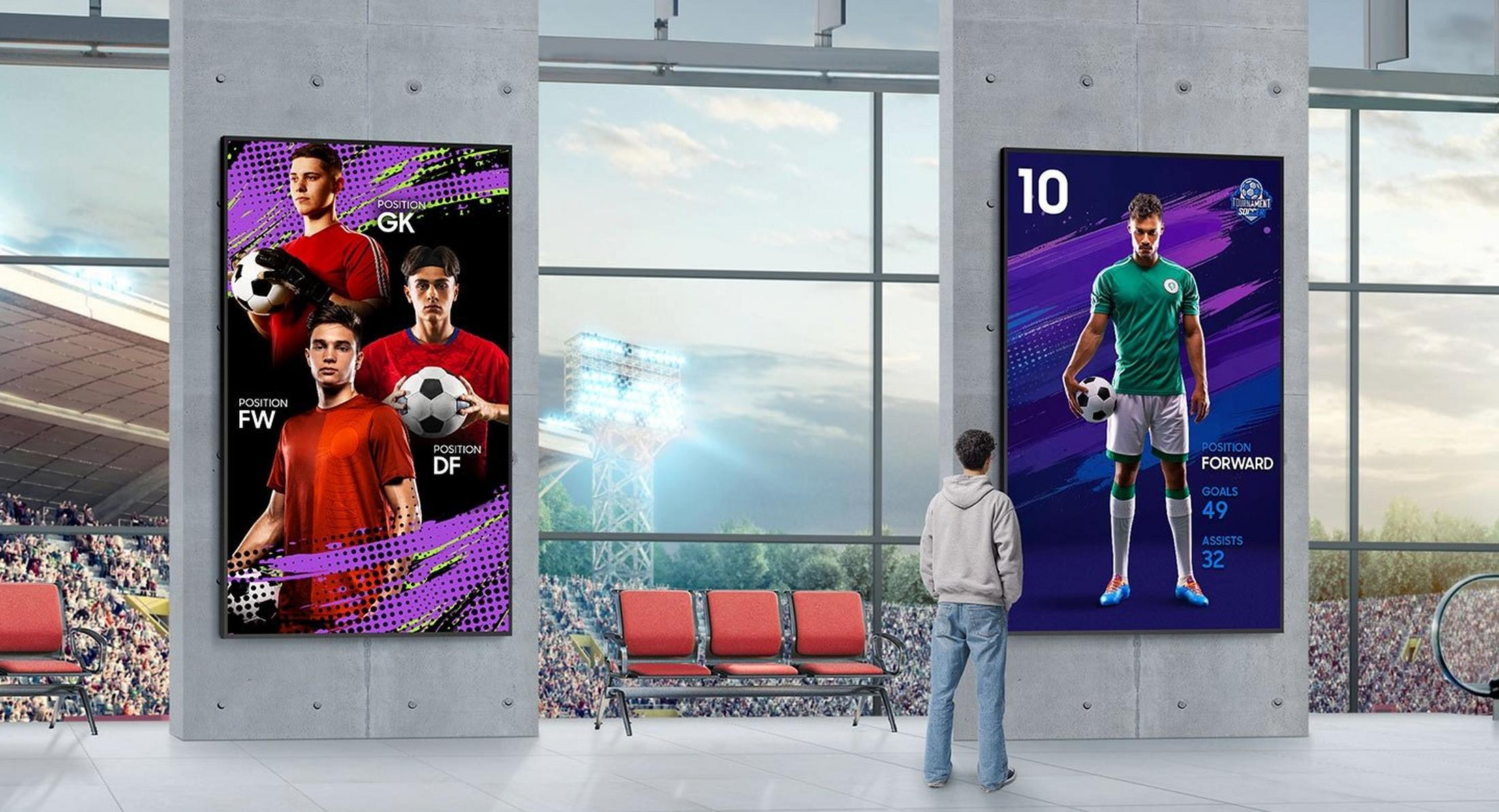 a man standing in a large room with a soccer poster on the wall