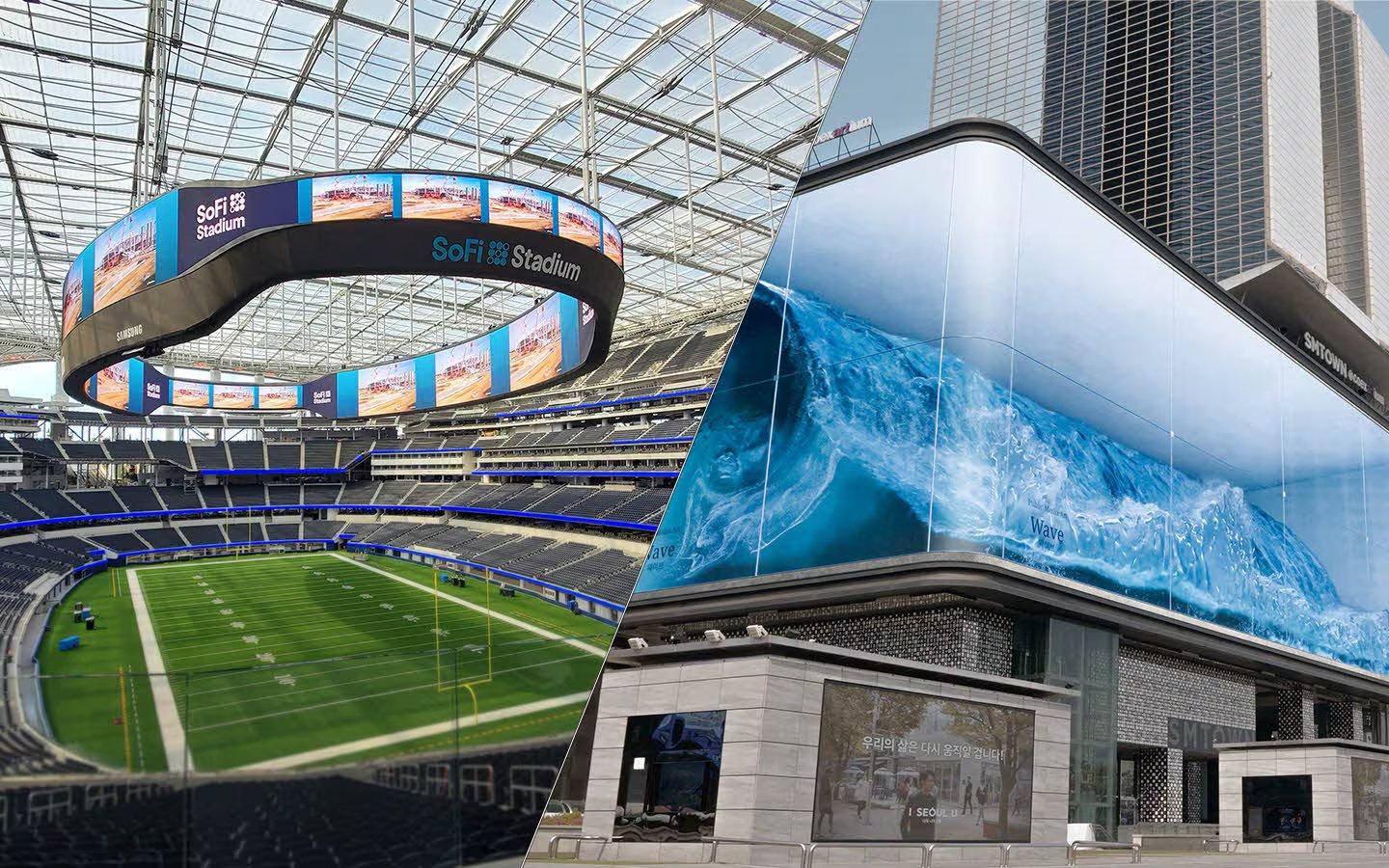 a stadium with a large screen and a building with a large screen