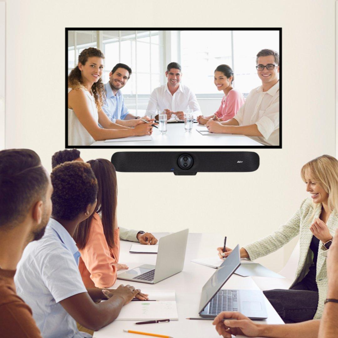 meeting room full of people looking at a screen