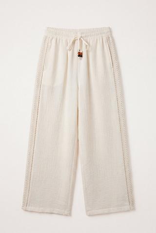CREAM LASER CUT PANTS
