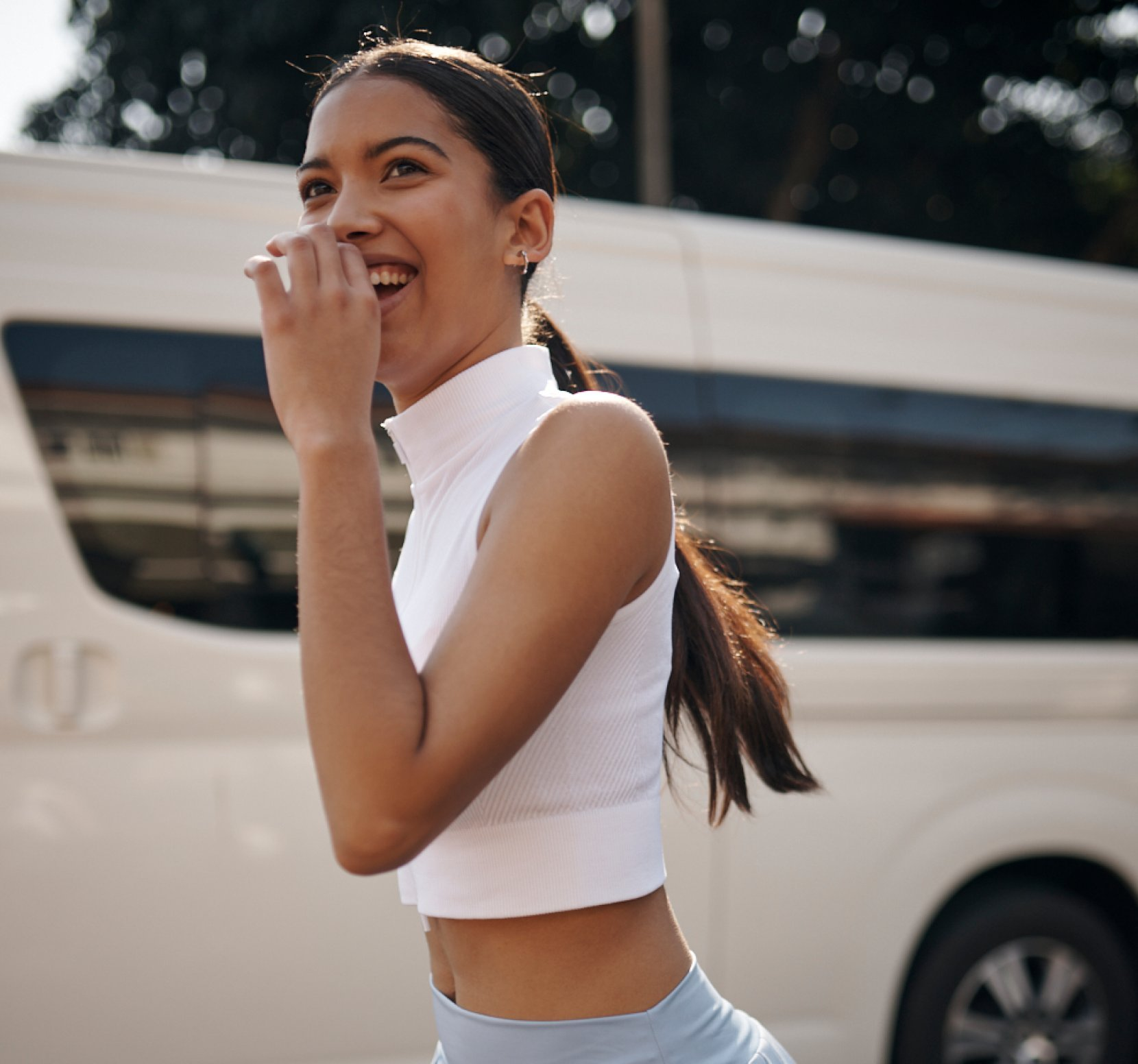 a baby wearing a pattern dress with pink, yellow and blue birds holding a toy