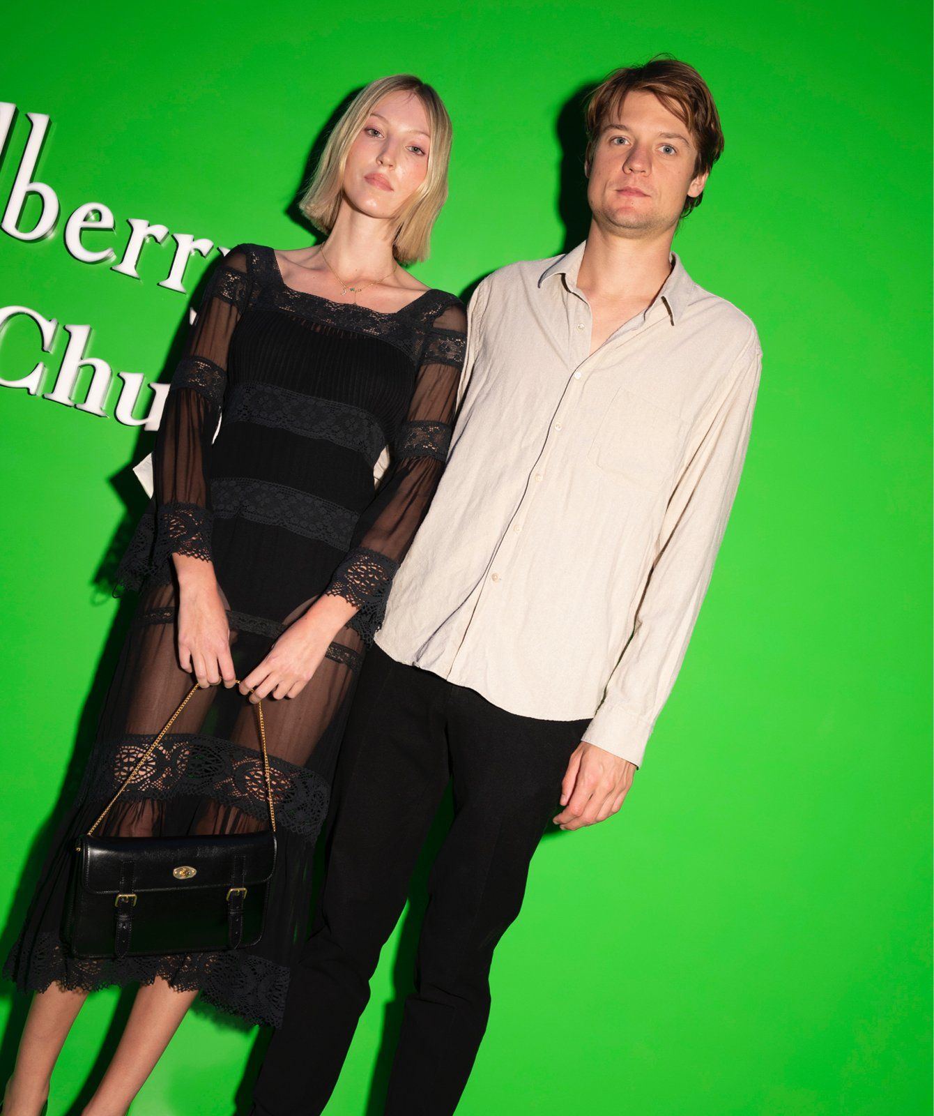 A couple posing during the launch event of the Mulberry x Alexa Chung collection