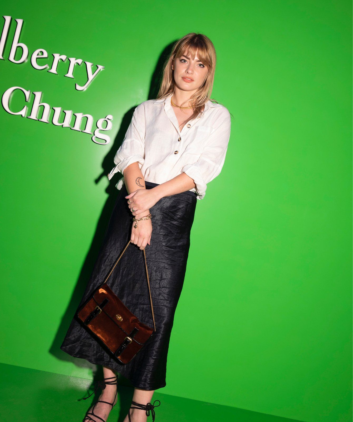 Blonde woman posing during Alexa Chung posing during the launch event of the Mulberry x Alexa Chung collection