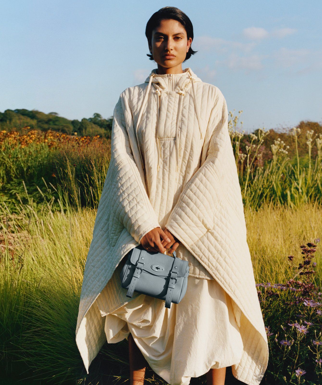 Model holding Mini Alexa in Cloud Small Classic Grain Leather