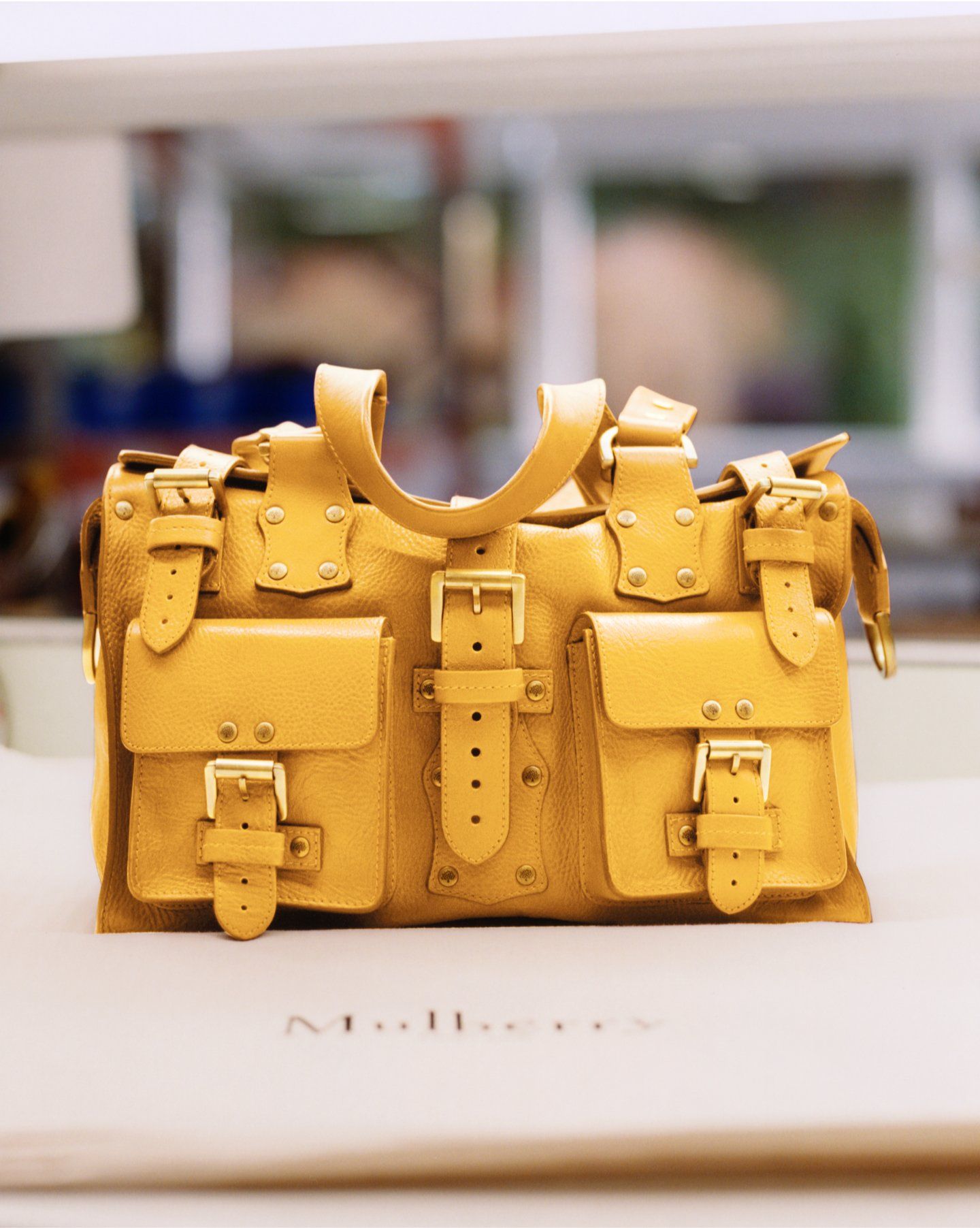 Handbag in yellow leather with pockets