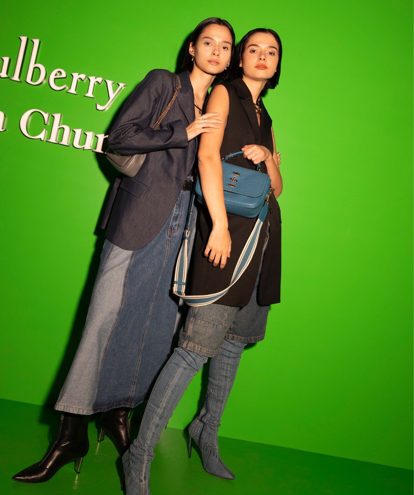 Two women posing during the launch event of the Mulberry x Alexa Chung collection