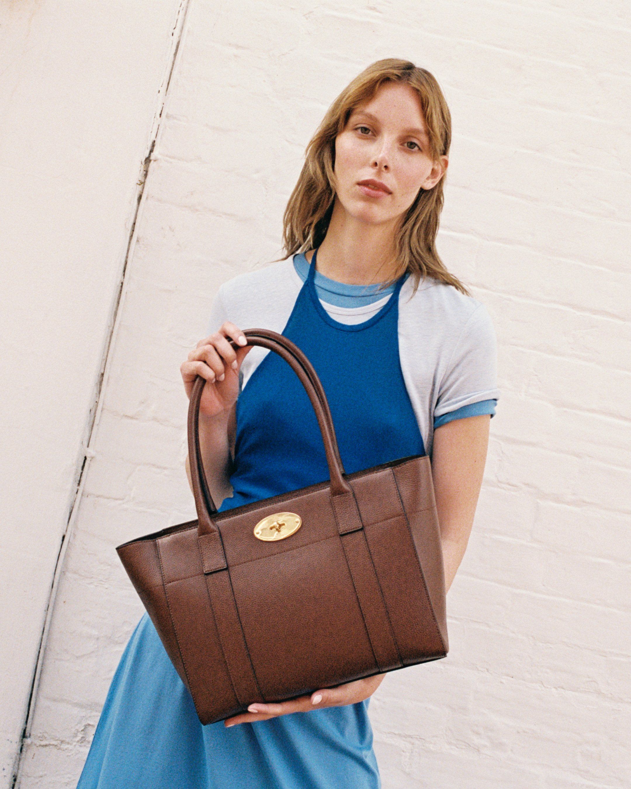 Female model wearing Mulberry Bayswater 9 to 5 tote bag in oak leather