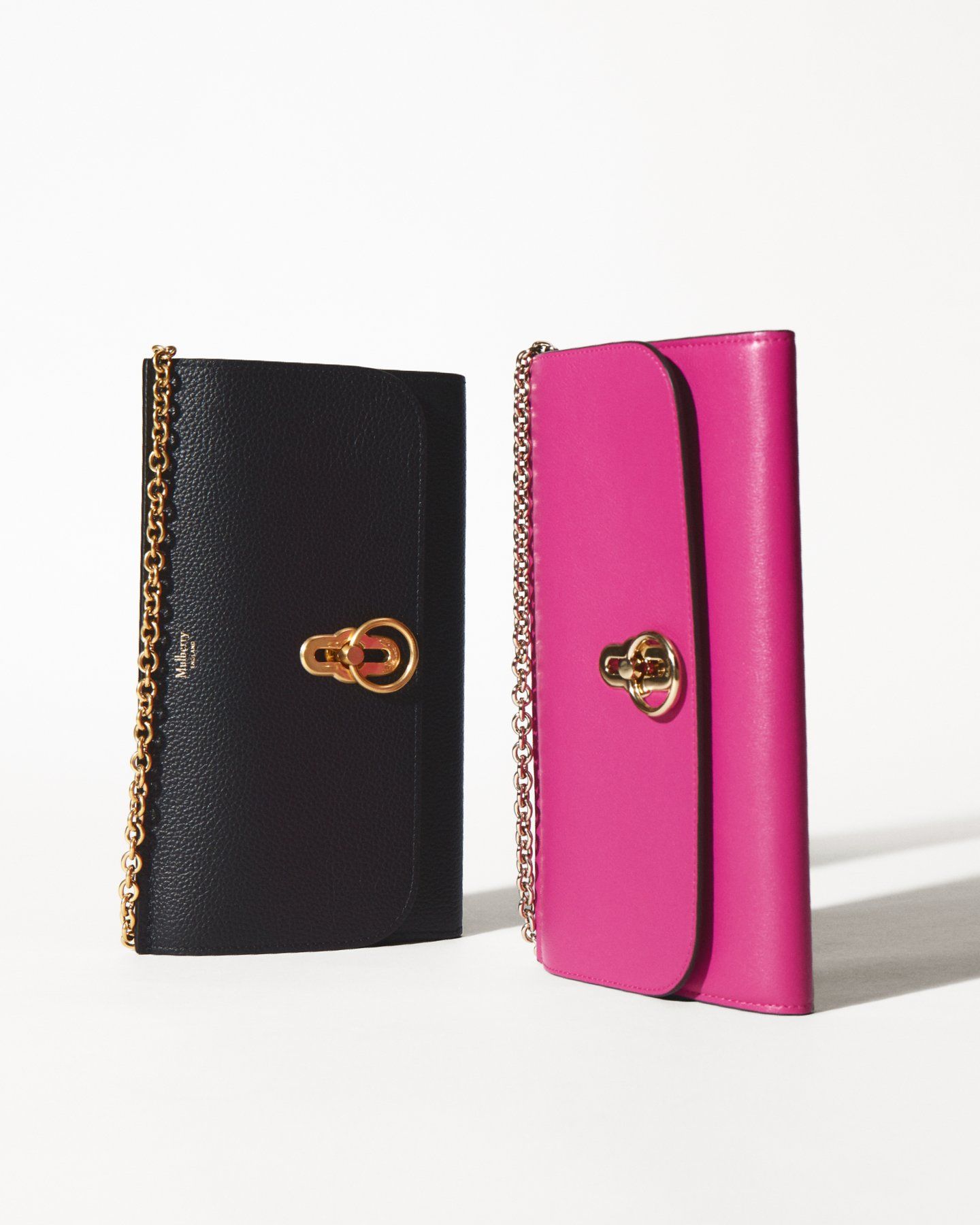 duo of mulberry amberley clutch bags in black and mulberry pink