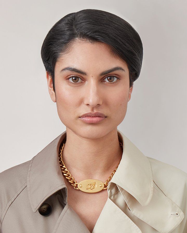 model wearing Axel Arigato for Mulberry Necklace in gold