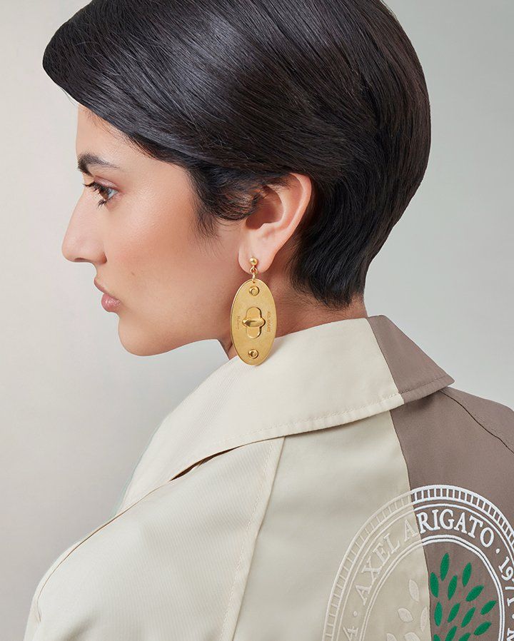 model wearing Axel Arigato for Mulberry Earrings