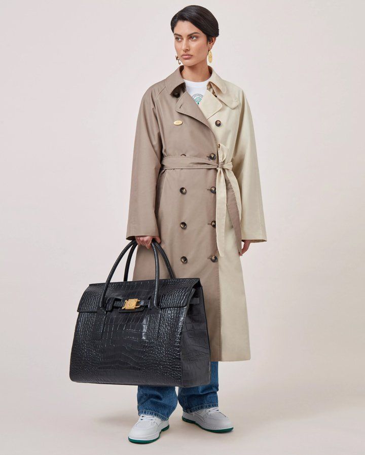 model holding Axel Arigato for Mulberry Tote Bag in black