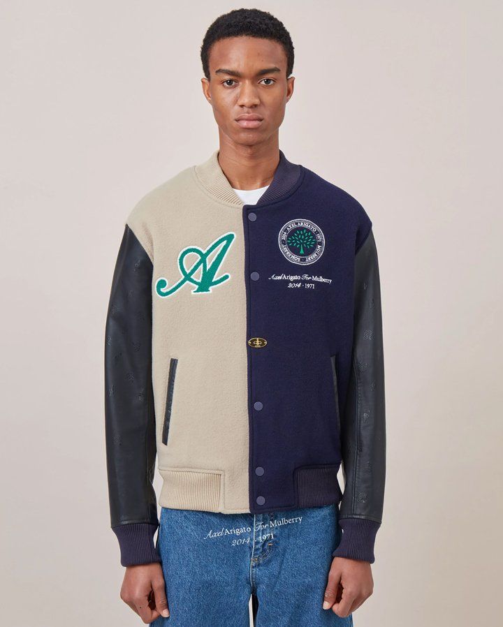 model wearing Axel Arigato for Mulberry Bomber Jacket in beige and navy
