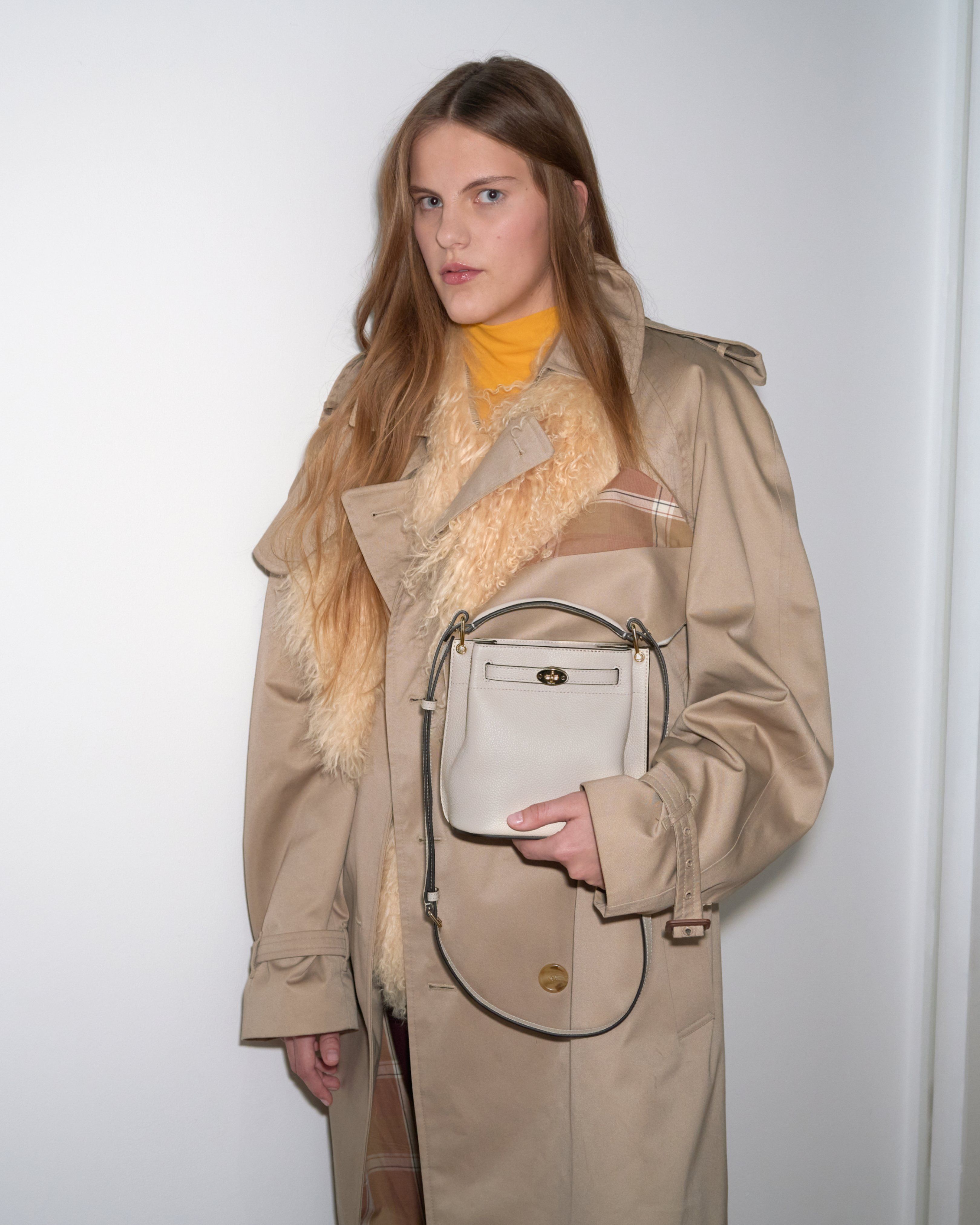 Model holding the Mulberry Islington Bucket bag in cream leather