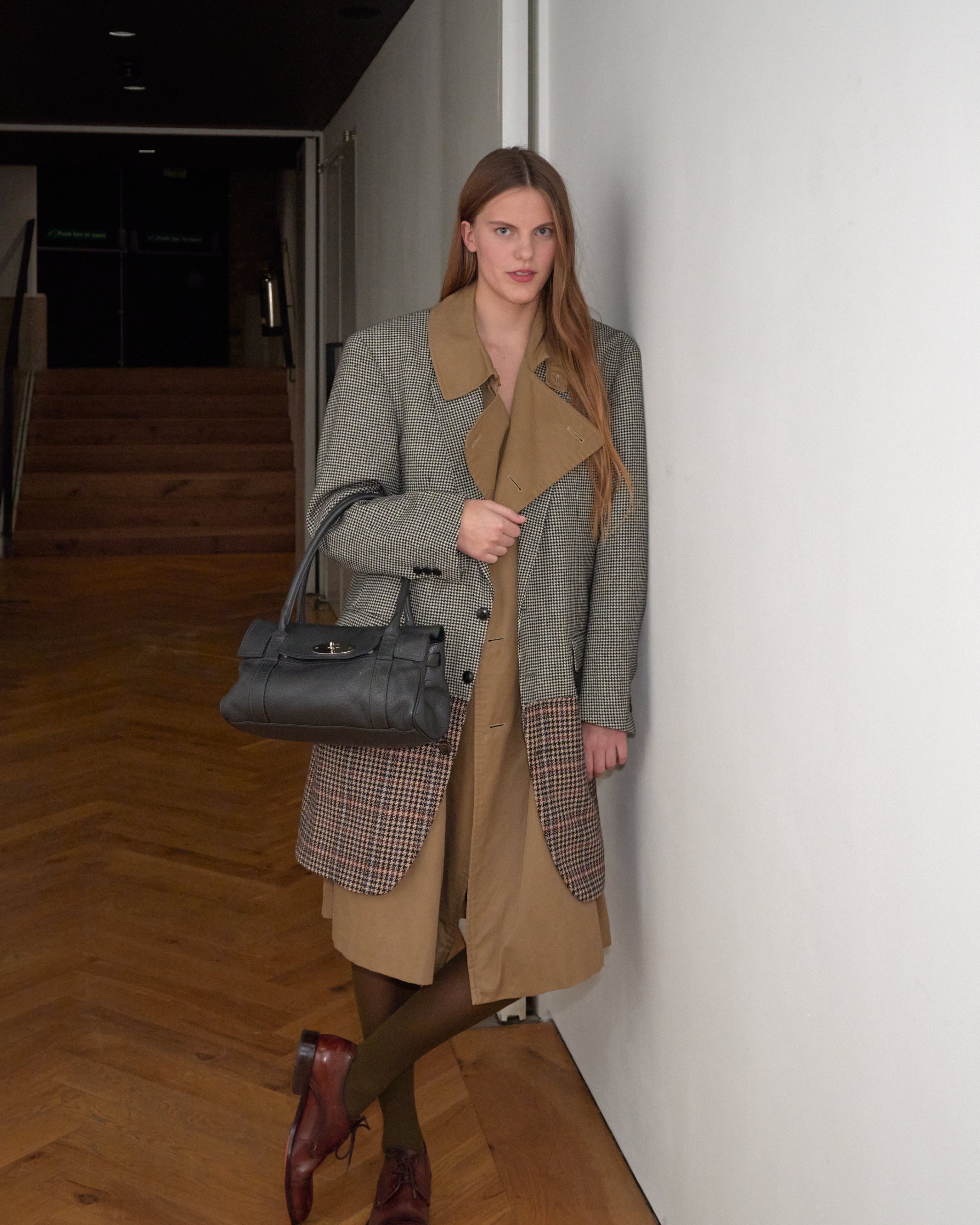 Model holding a Mulberry pre-loved bag