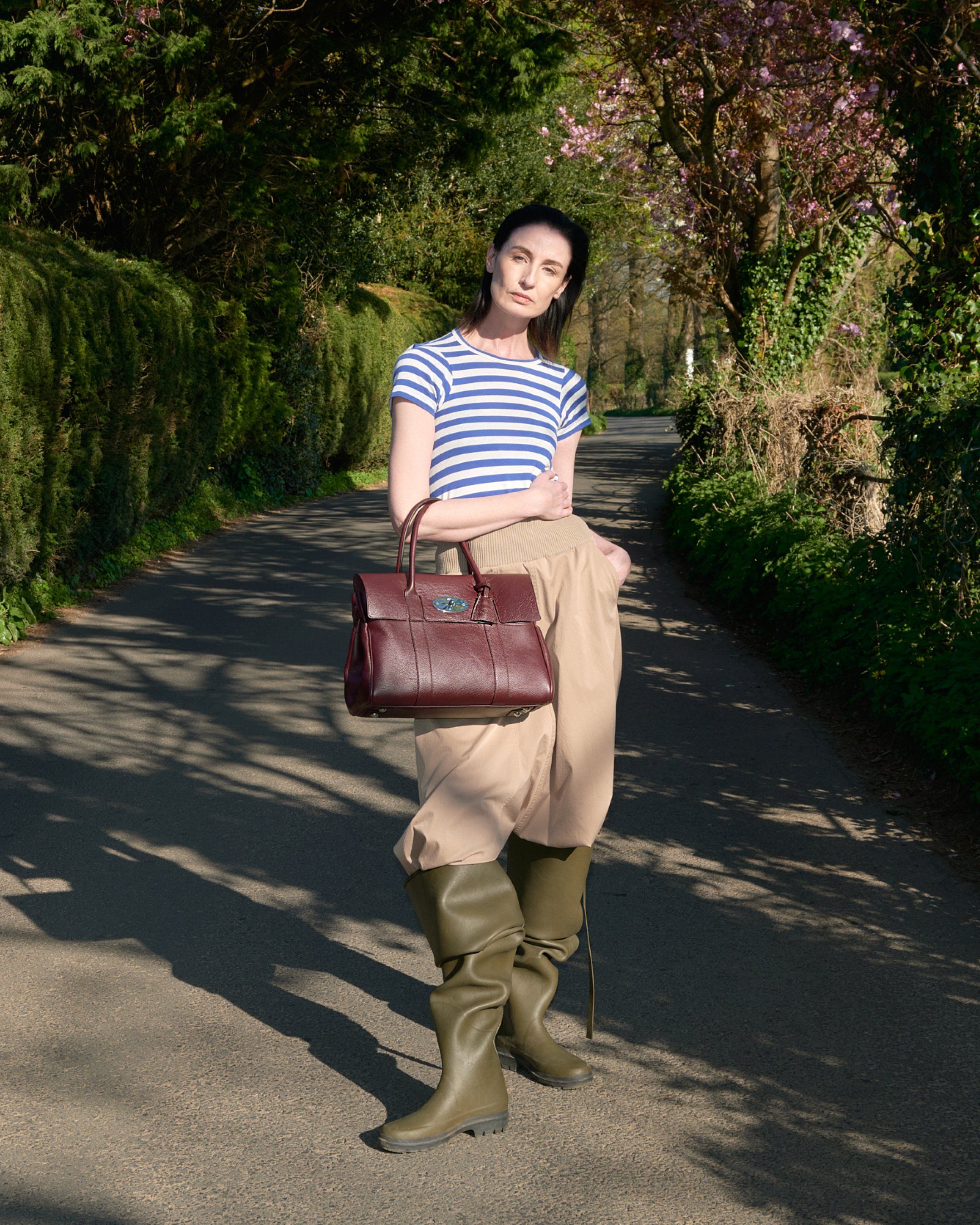 Female model wearing Mulberry Bayswater bag in burgundy leather