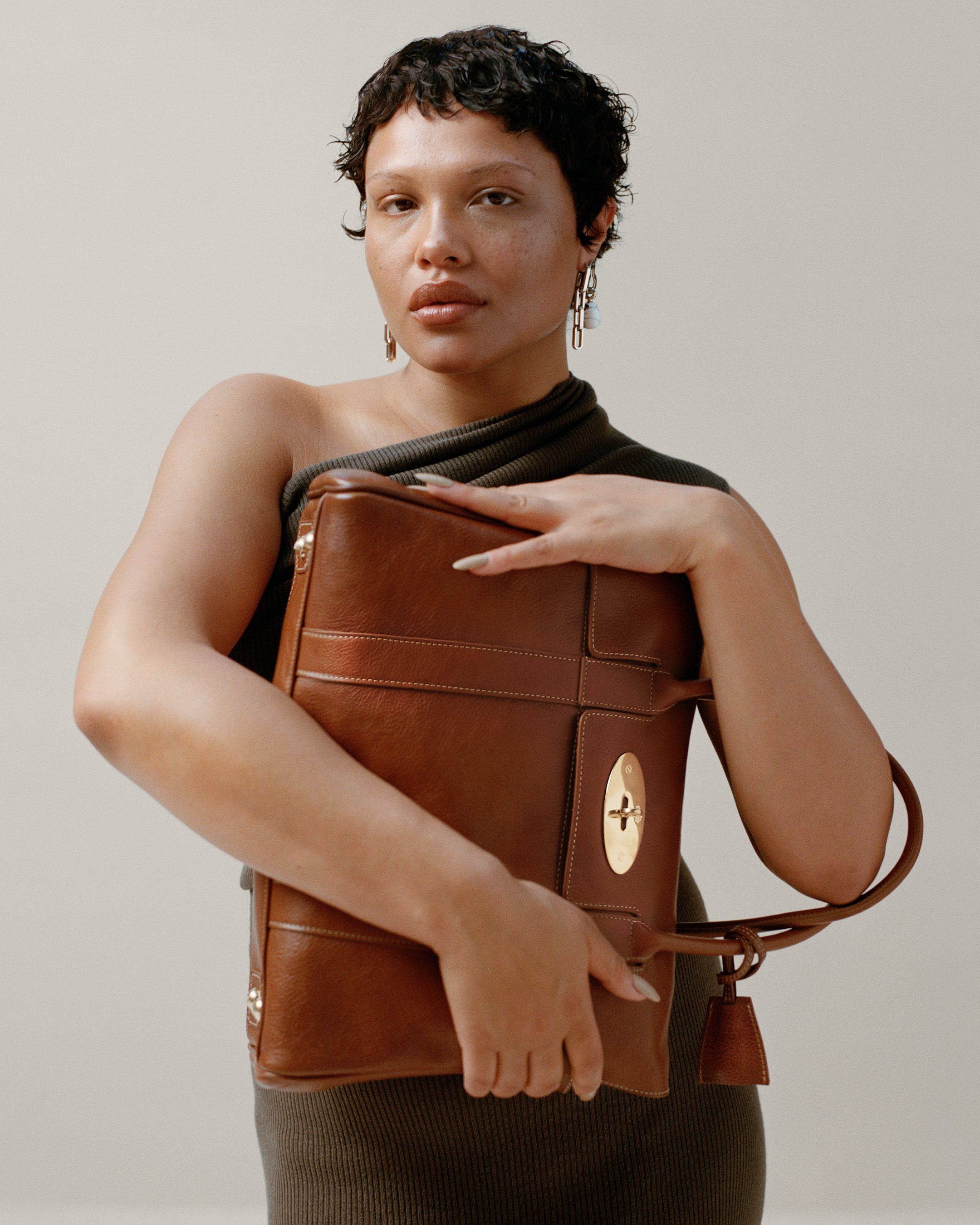 Model holding the Bayswater handbag in oak leather