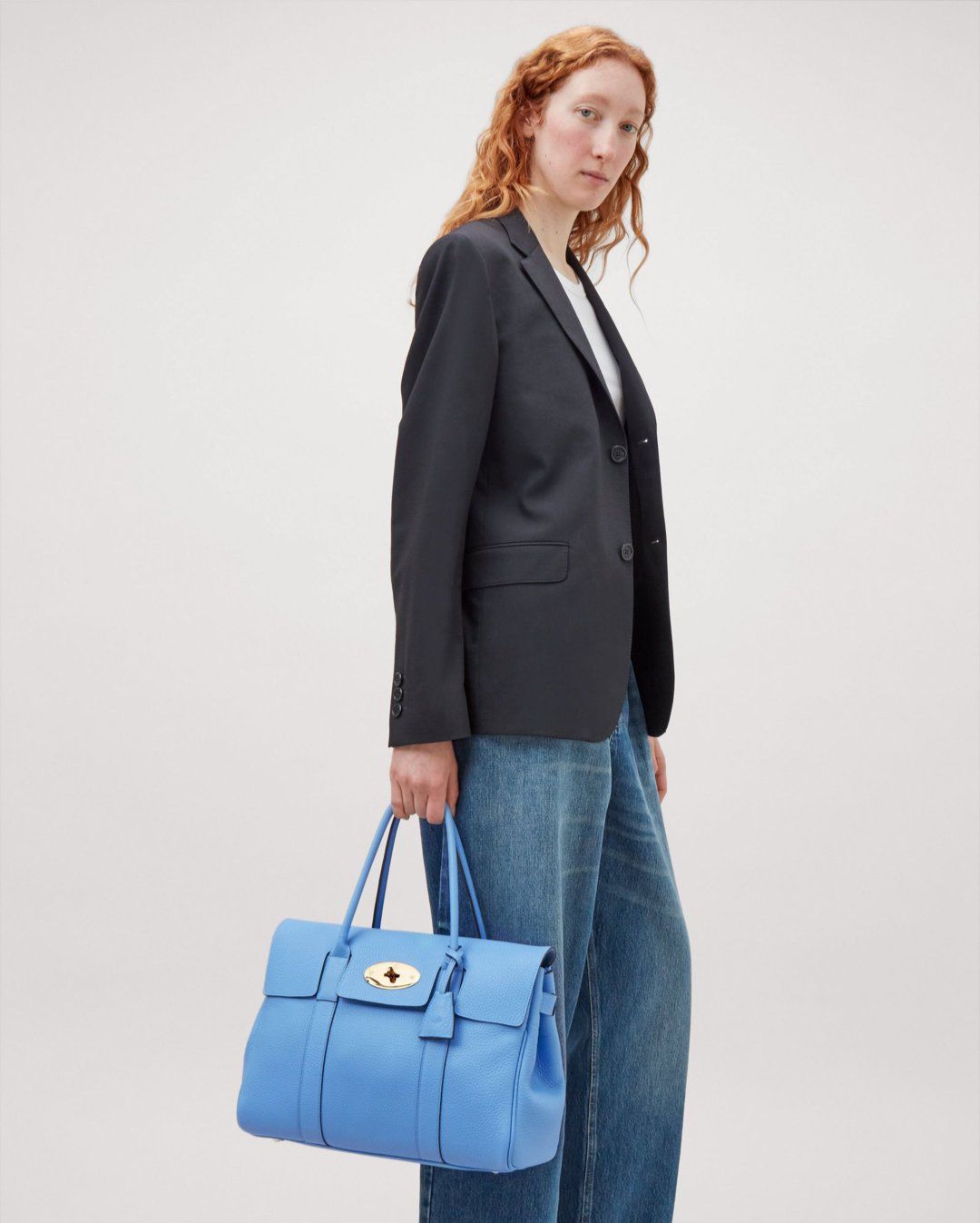 Model holding the Bayswater in Cornflower Blue Heavy Grain