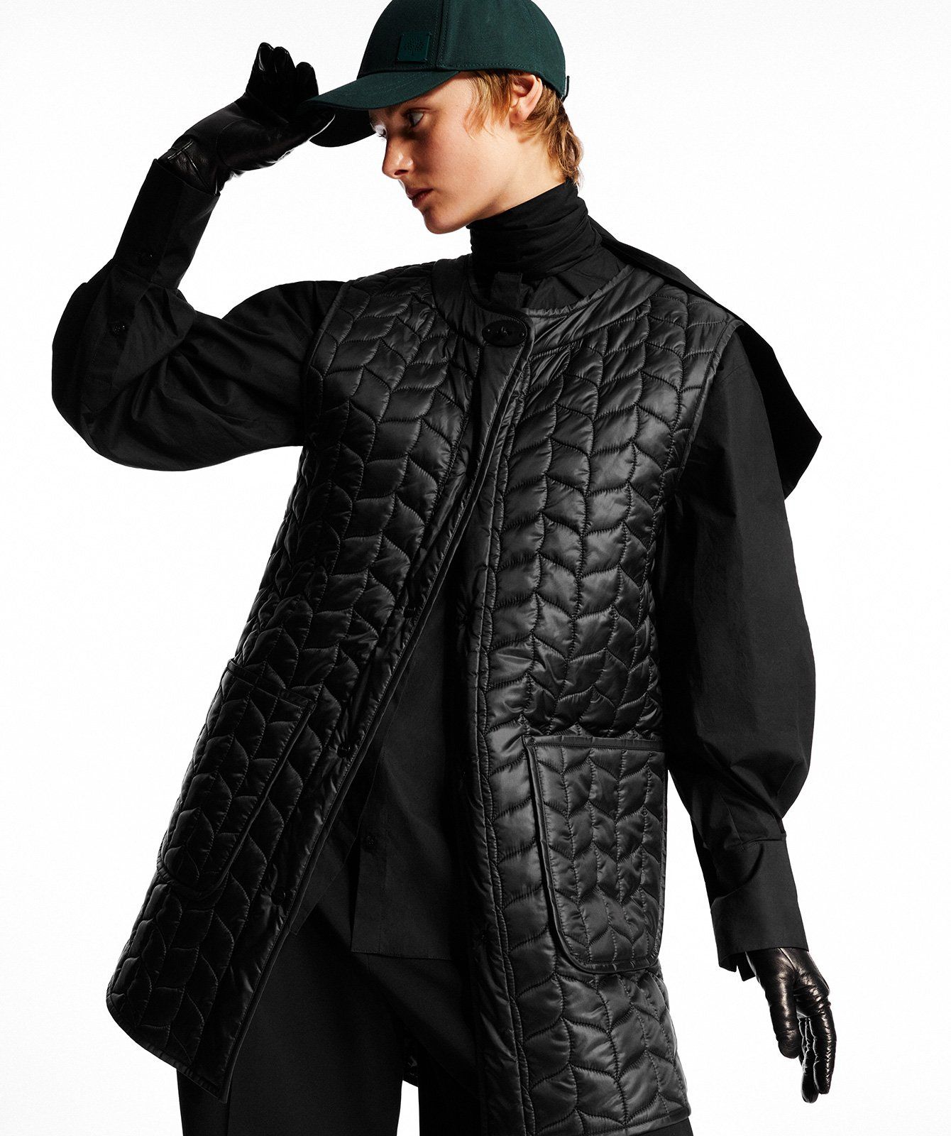 Model wearing the Softie Quilted Sleeveless Coat in Black