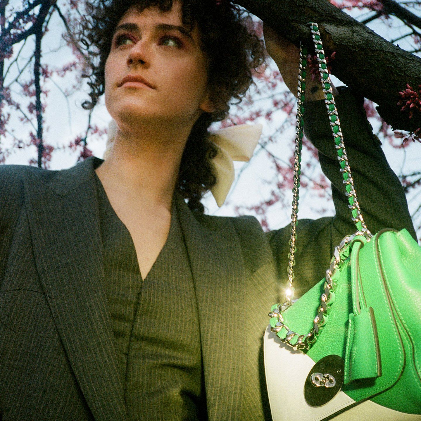 Model holding a Lily handbag in green and white