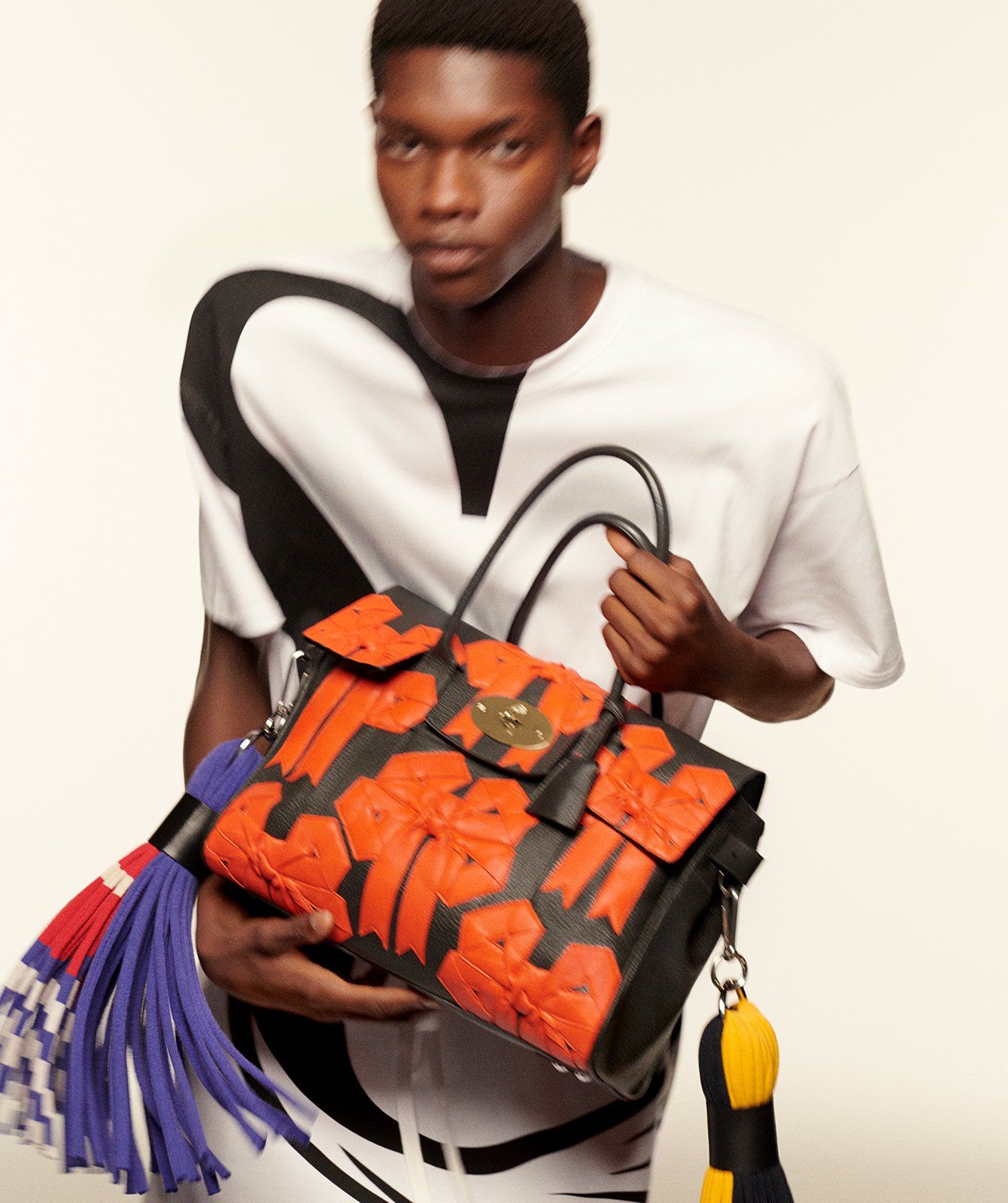 Model holding the Bayswater Bow 04 Handbag in Charcoal Spongy Pebbled Leather with Tassels