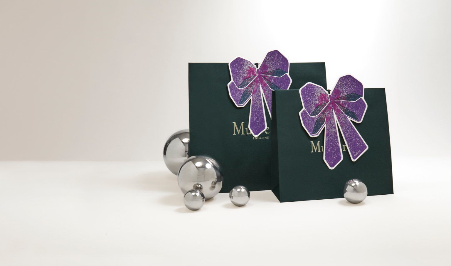 Mulberry packaging with festive purple bow tag