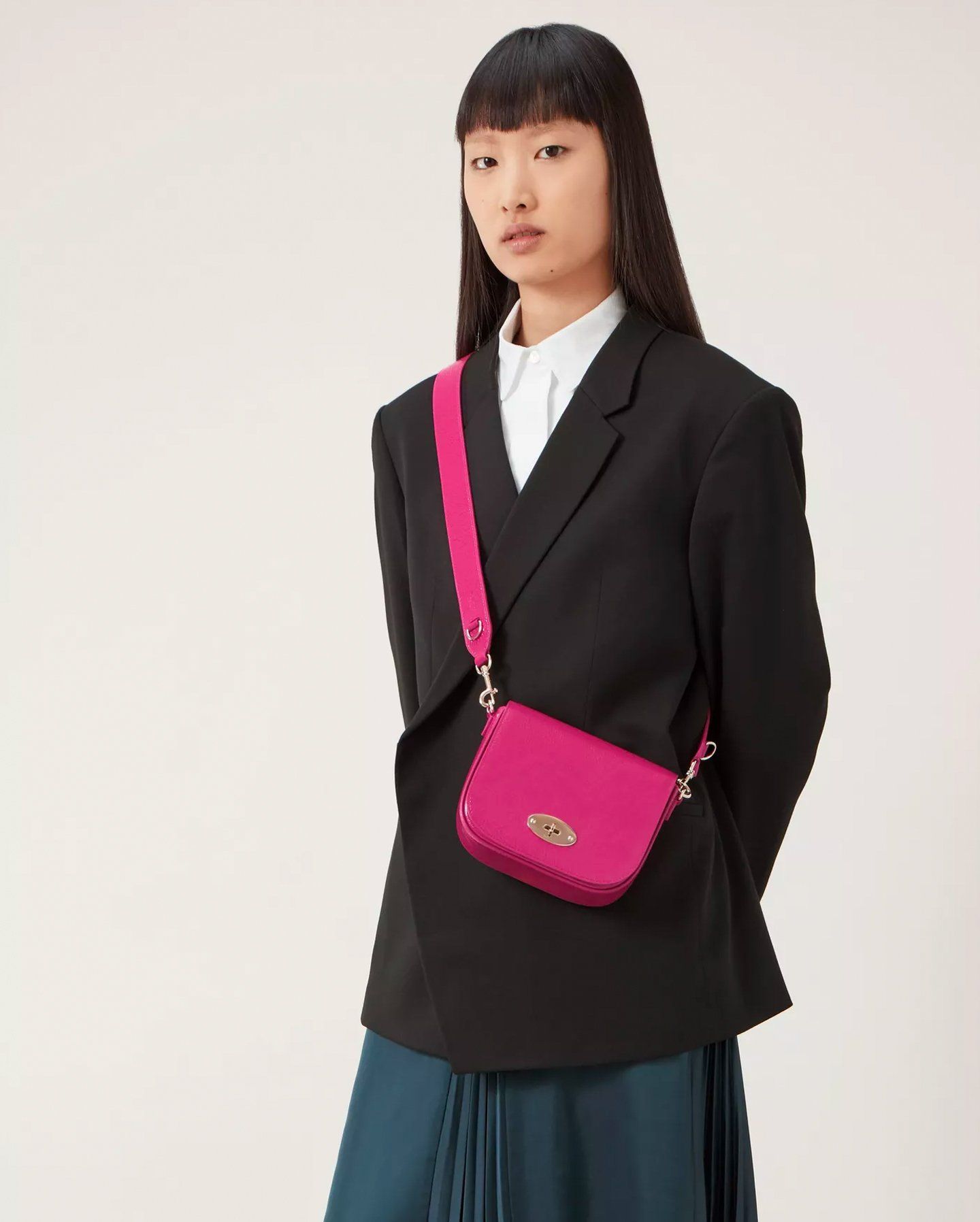 Model wearing Small Darley Satchel in Mulberry Pink Spongy Patent