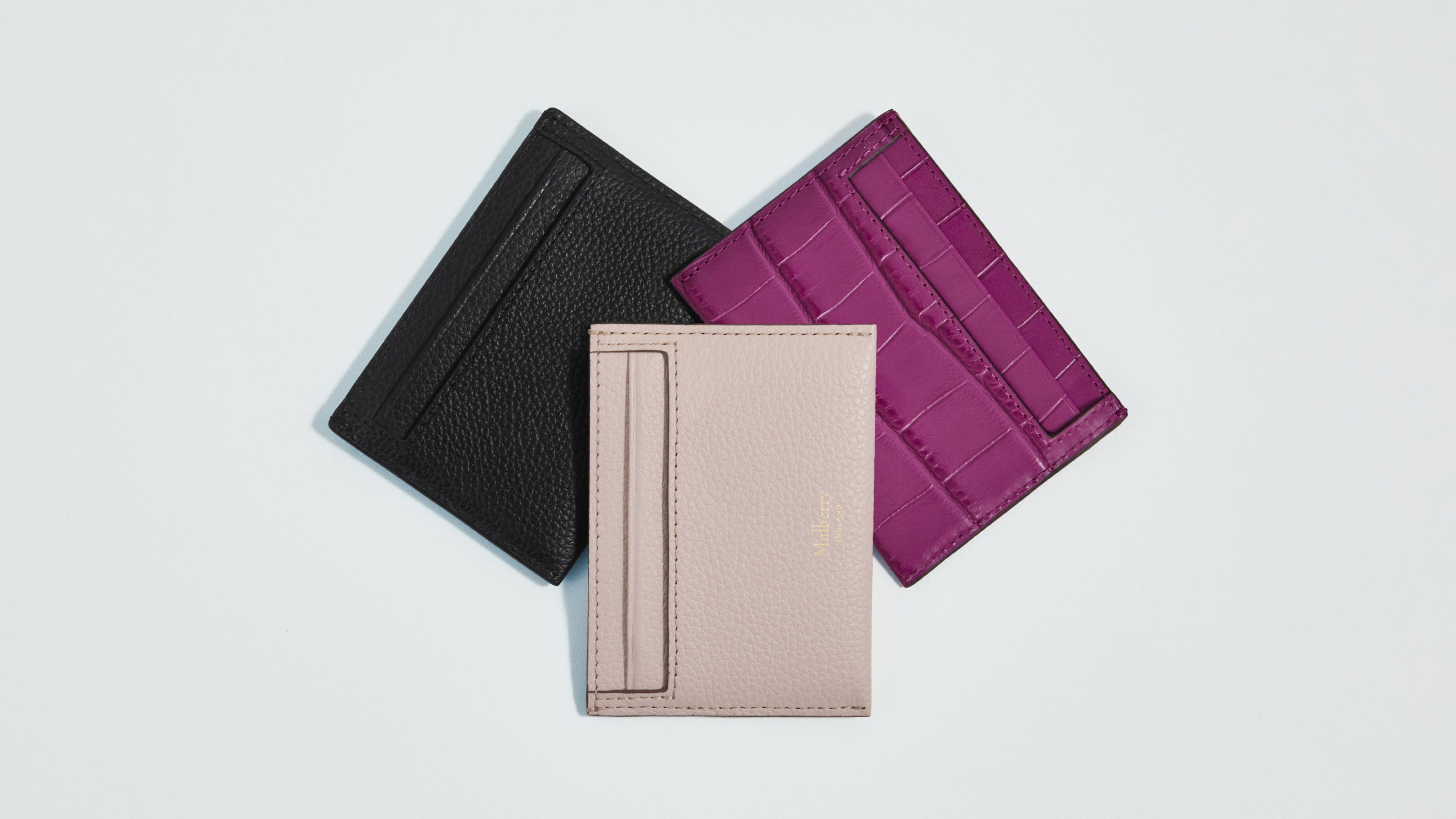 Three Mulberry credit card slips in pink, purple and black leather