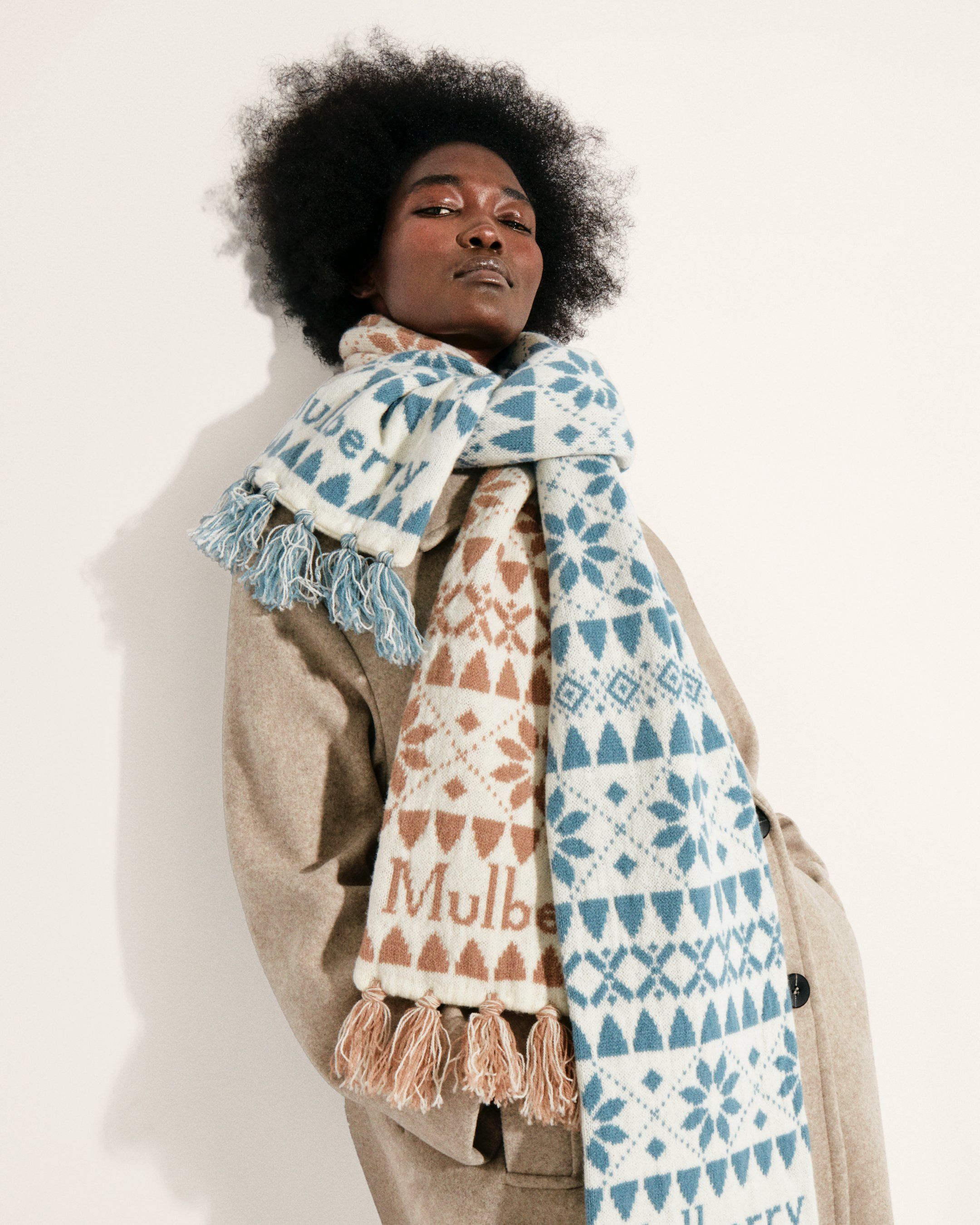 Model wearing Mulberry fairisle scarves in poplin blue, teak and ecru