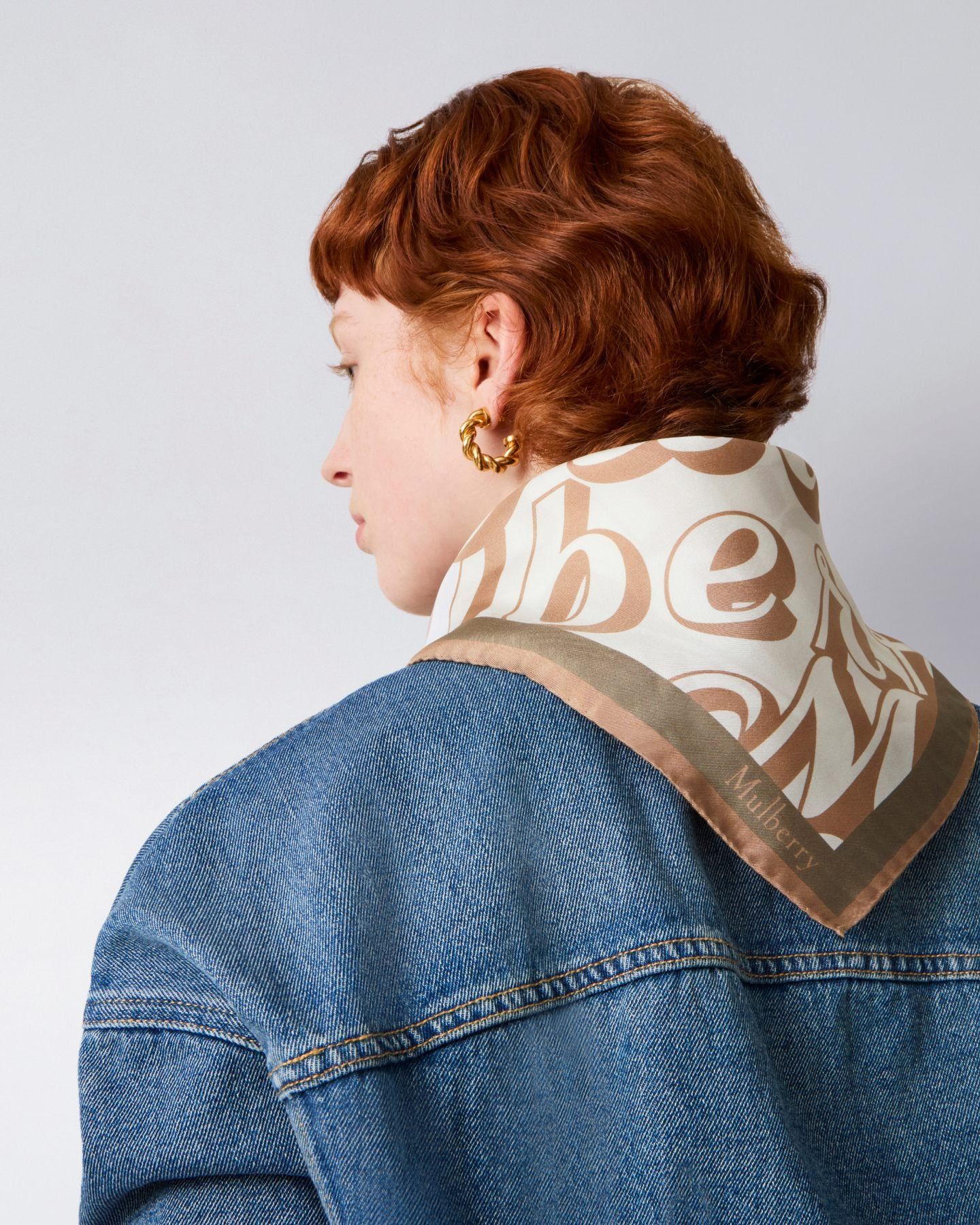 Model wearing Mulberry fantasy logo square scarf