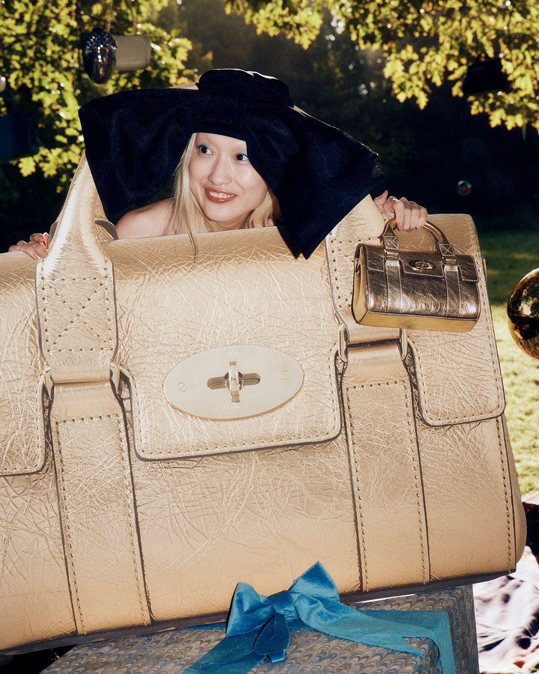 Girl holding Mini and Large Gold Bayswater