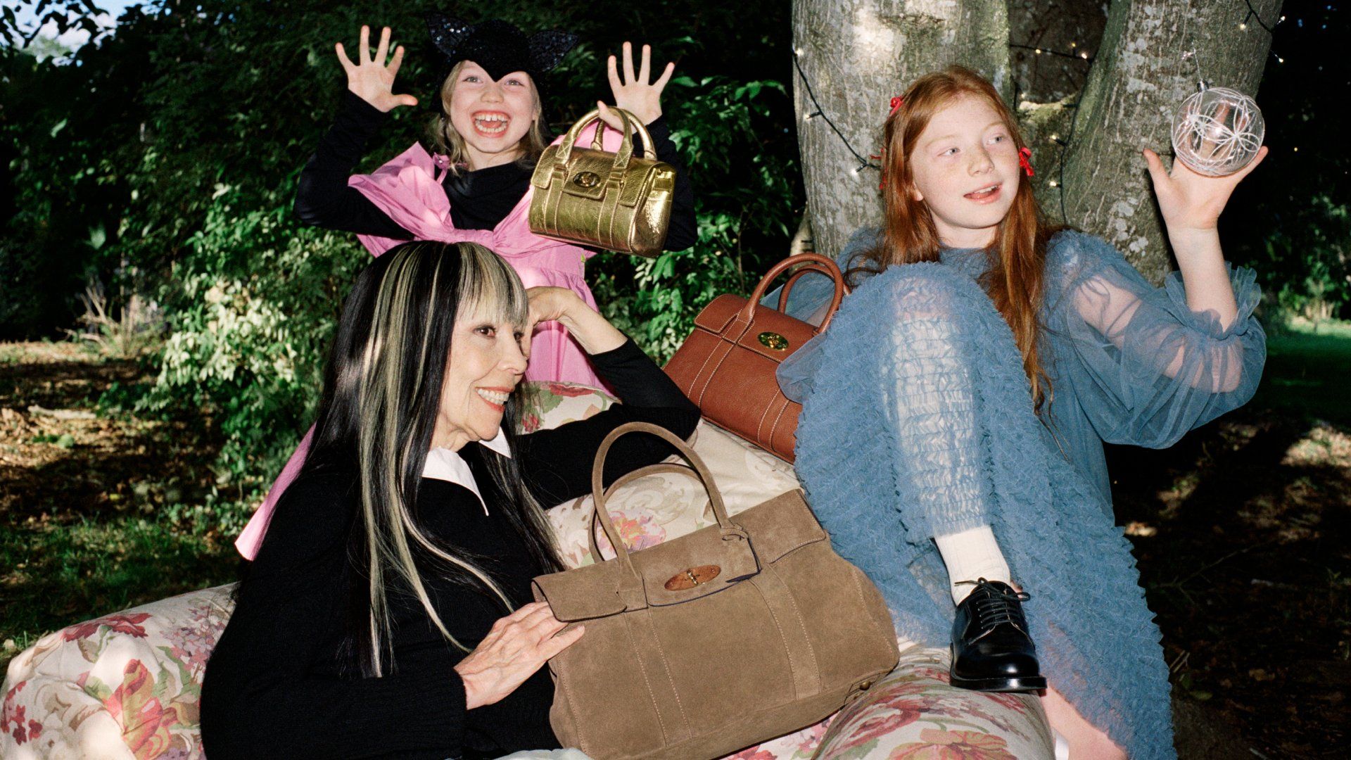 2 girls and a woman holding up Bayswater handbags