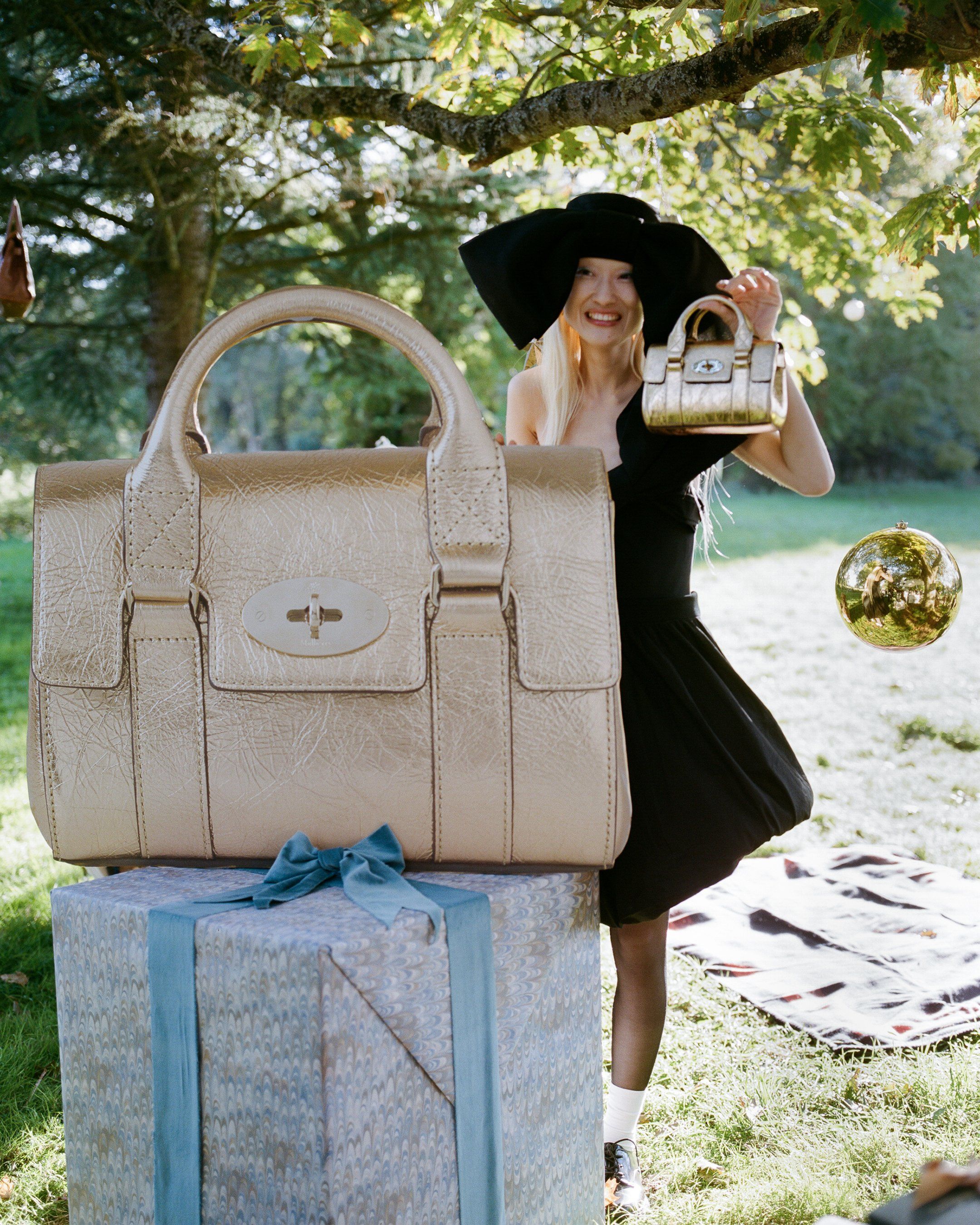 model hiding behind gold bayswater