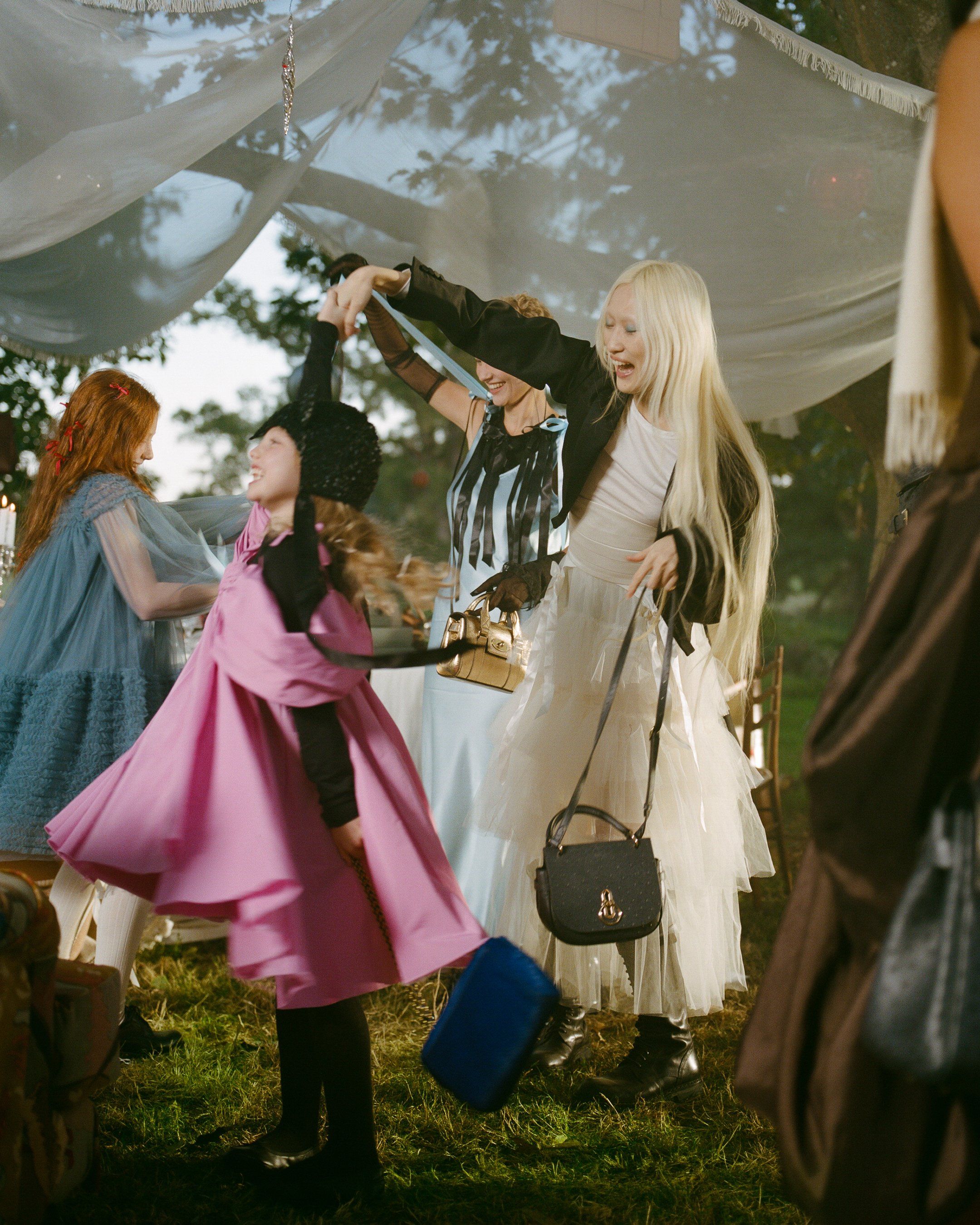 Lady holding Amberley dancing with Girl holding Lily