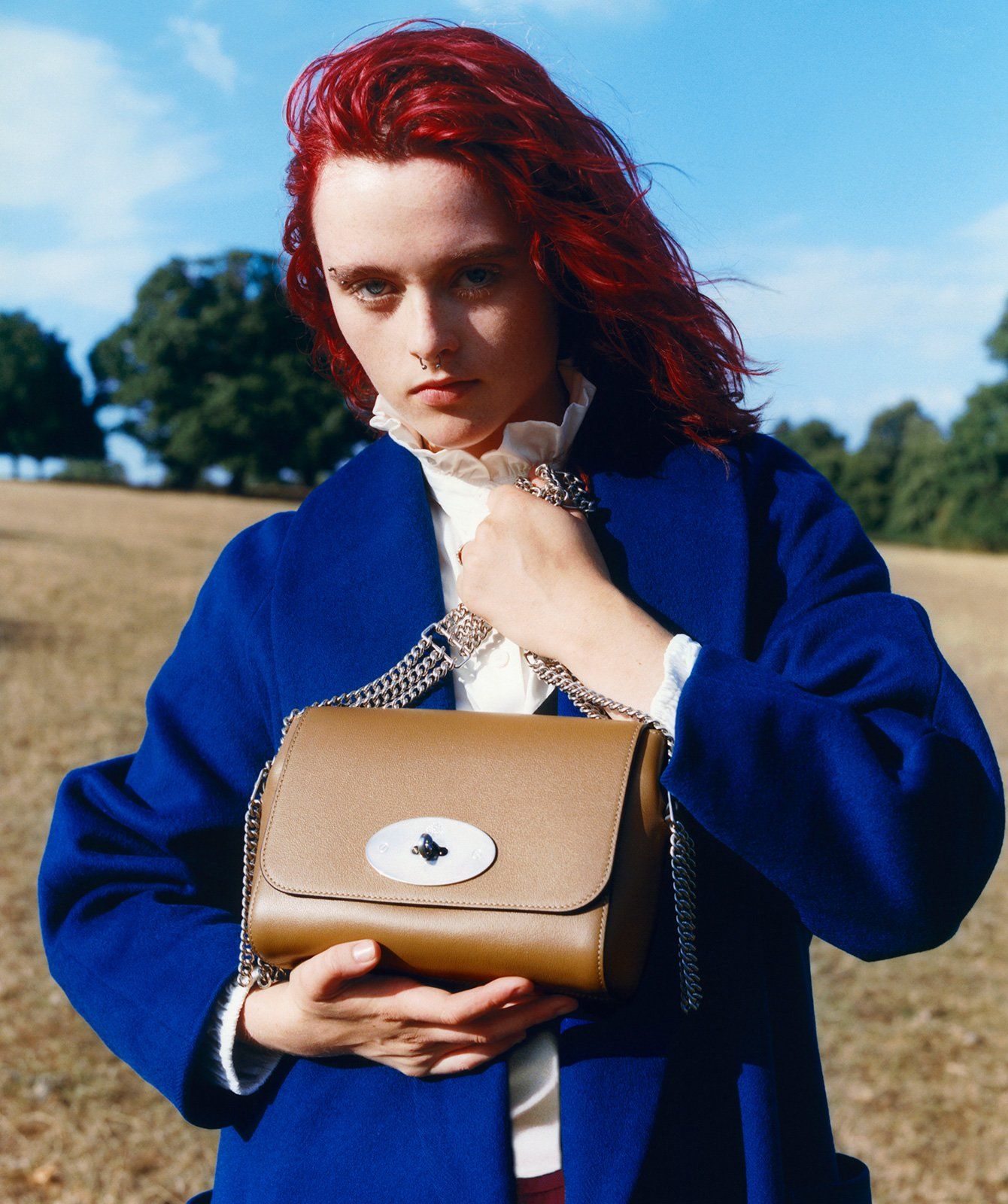 Model holding the Lily bag in brown leather