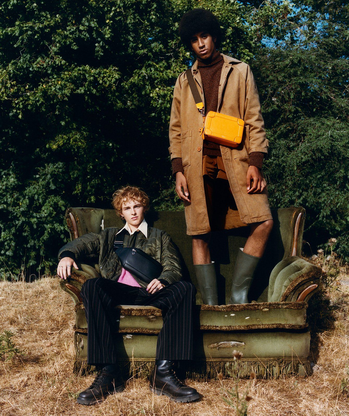 Two models wearing a black bag and yellow bag
