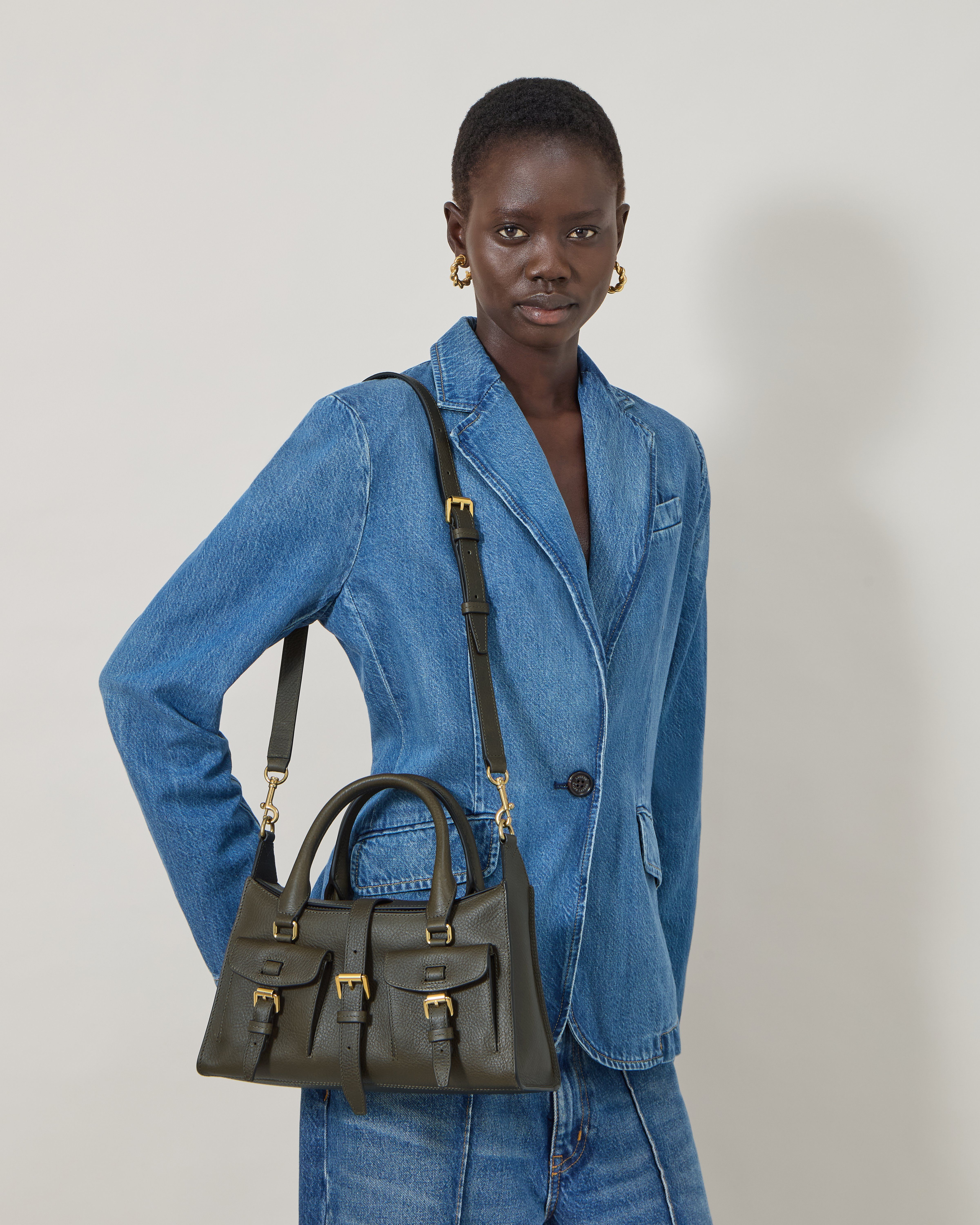 model wearing Mulberry small Roxanne bag in sage green leather