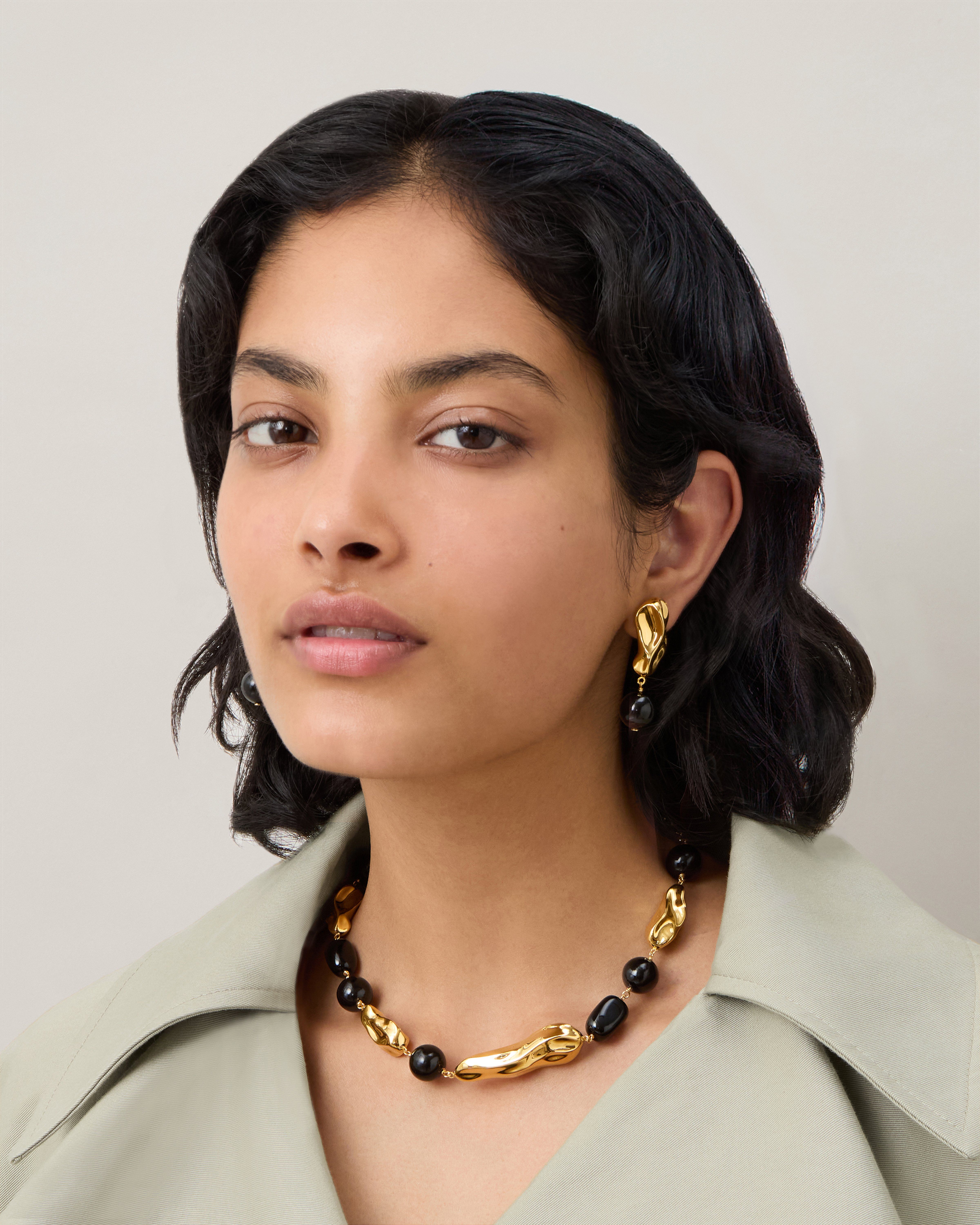 Model wearing the Mulberry x Rejina Pyo Textured Beaded Earring in Brass & Gold