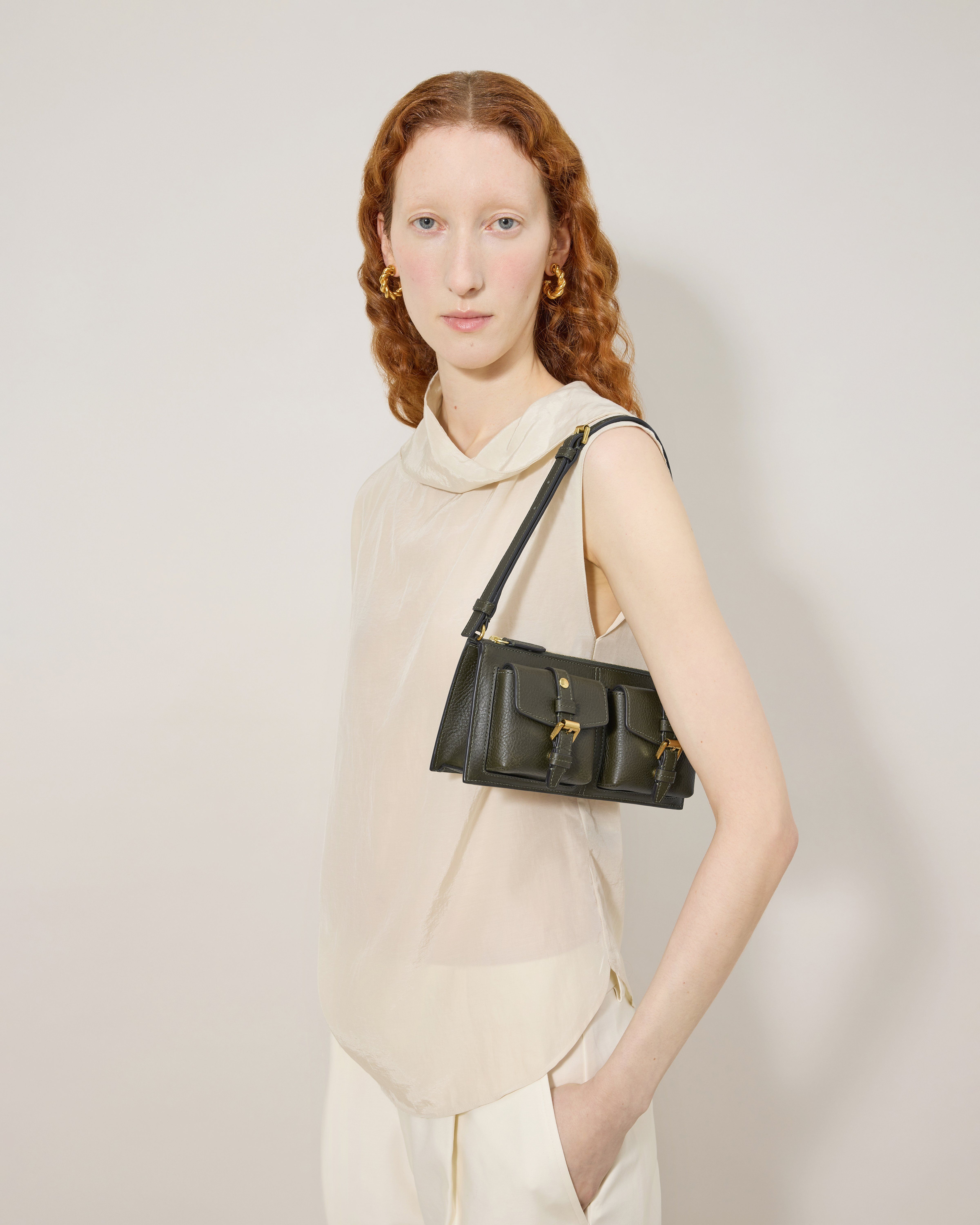 Model wearing sage green Mini Mulberry handbag