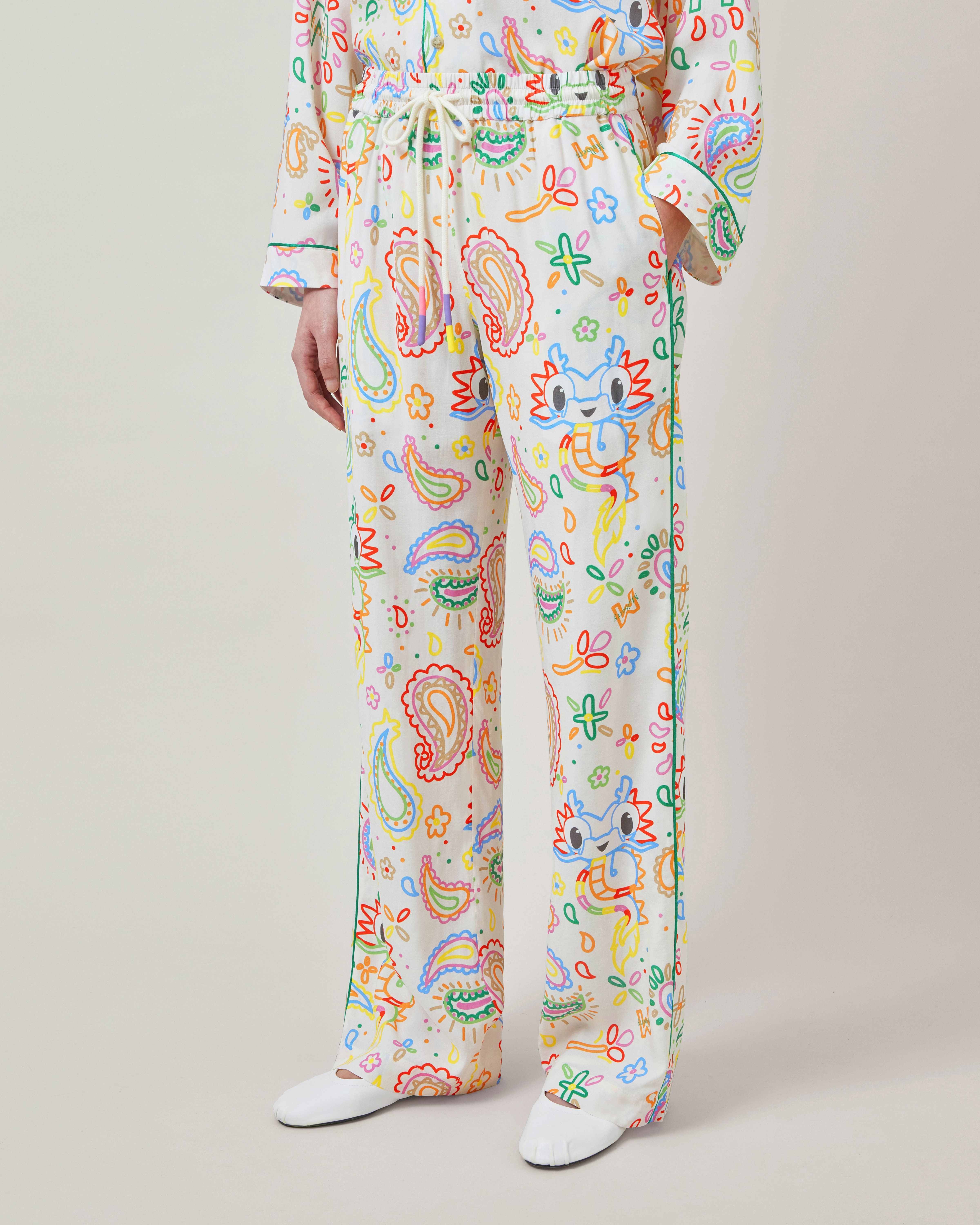 Model wearing Mulberry x Mira Mikati Dragon Printed Relaxed Trousers multicoloured