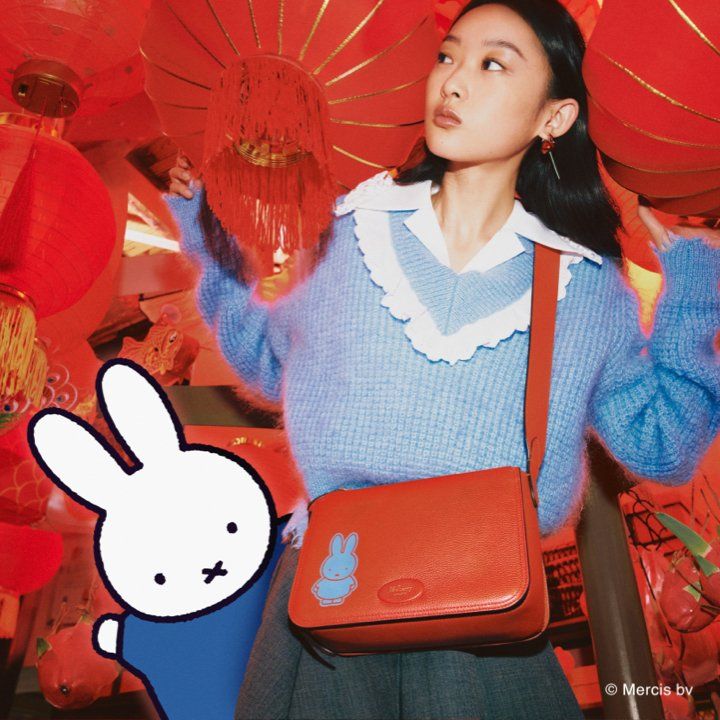 Model wearing Mulberry x Miffy Bille bag in Coral Orange