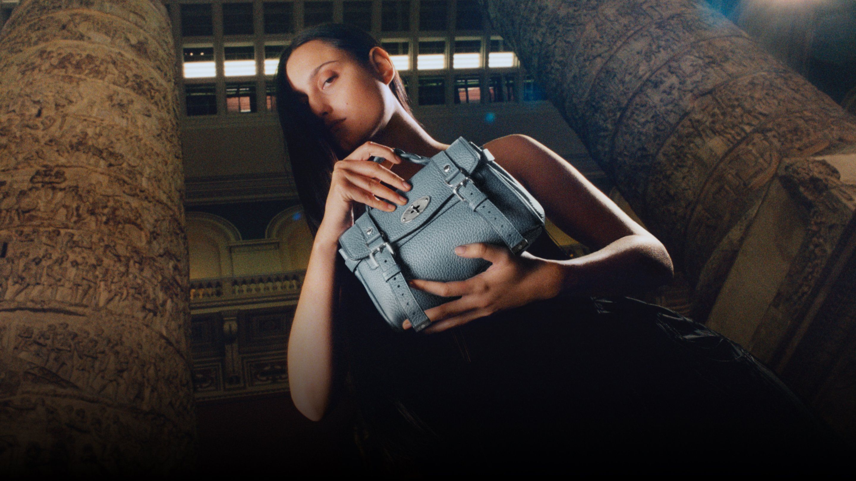model holding mulberry mini alexa bag in cloud
