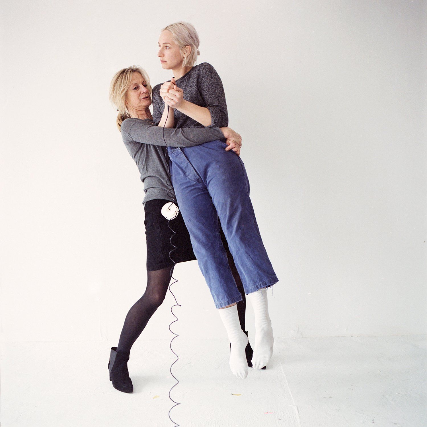 Image of one woman lifting another woman