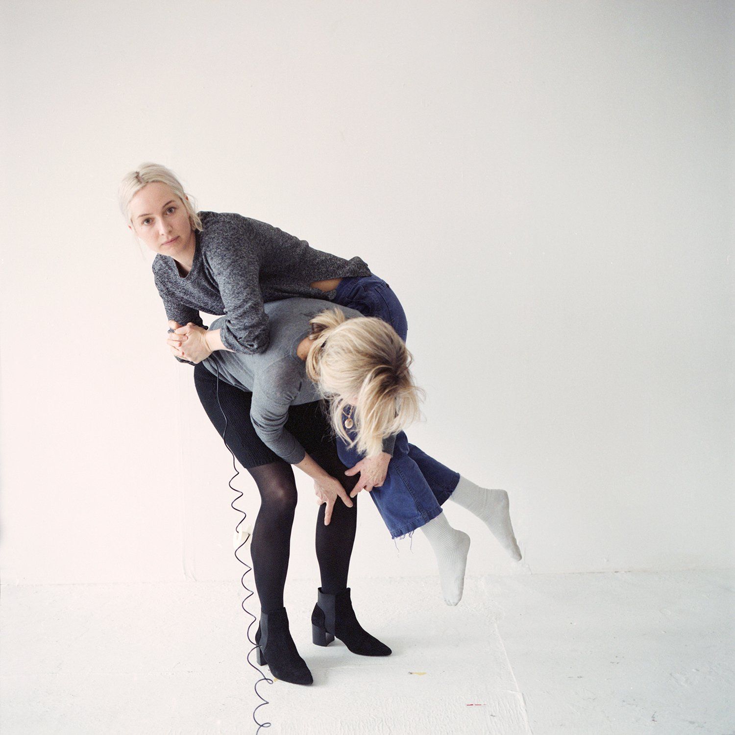 Woman holding another woman over her back