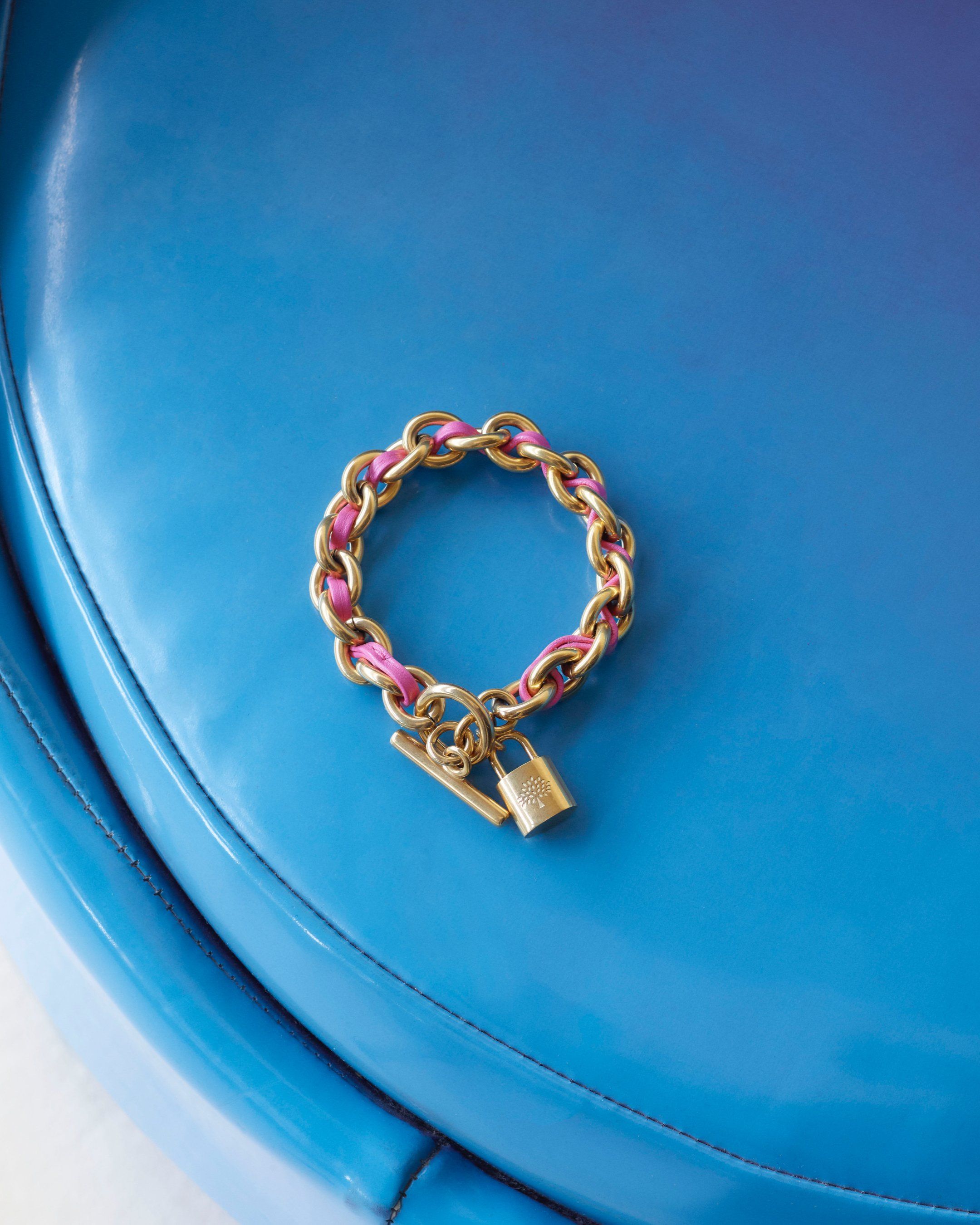 mulberry lily leather chain bracelet in gold and geranium pink