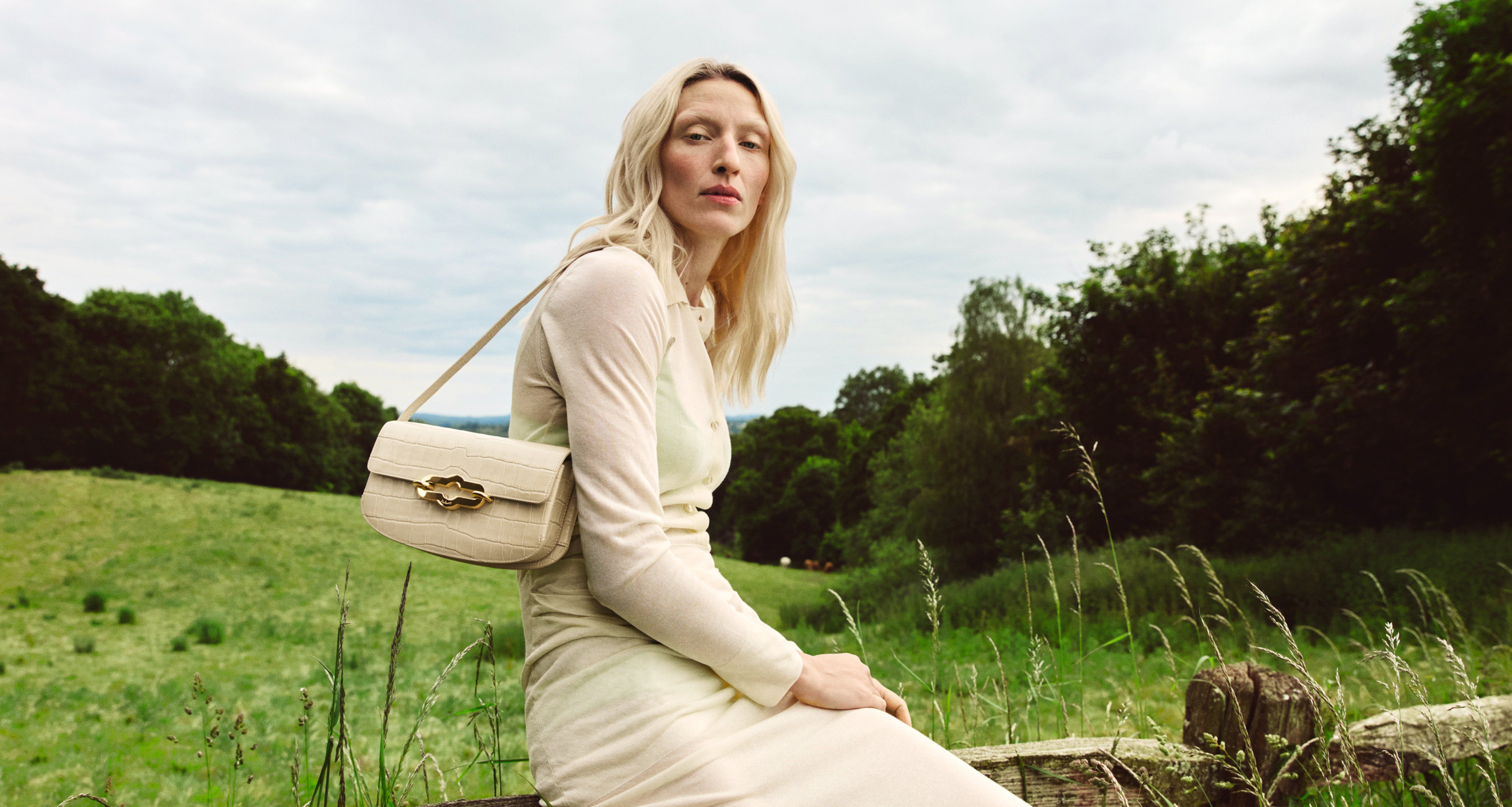 Model wearing Mulberry East West Pimlico bag in Eggshell Croc print