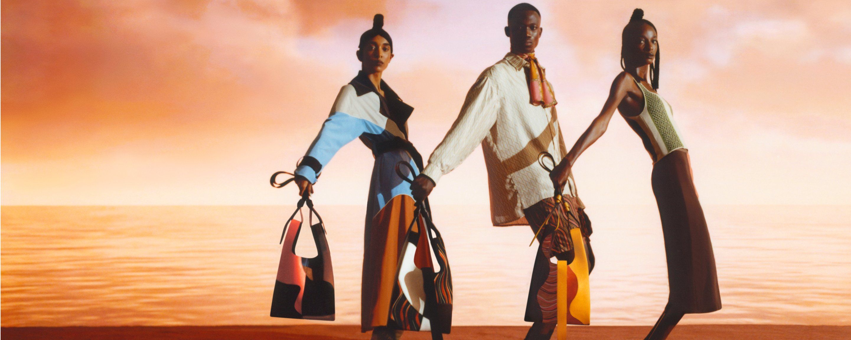 Three models holding Portobello bags